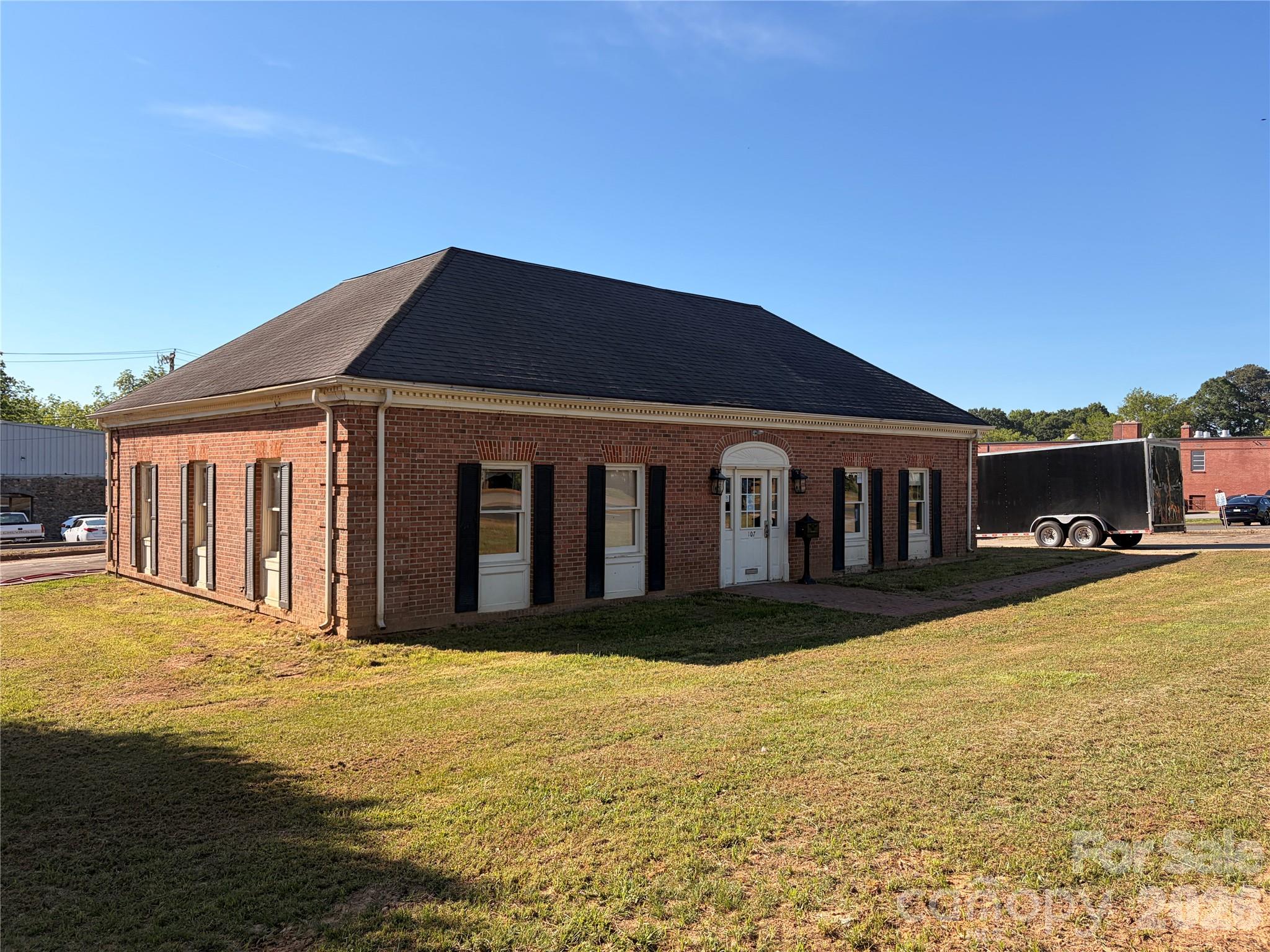 Discover an exceptional investment or owner use opportunity in the heart of downtown York, SC. Located at 107 S. Congress St. This 1,800 SF solid brick office building offers prime visibility and a classic exterior. The interior features a highly versatile layout, including a large, welcoming open lobby/reception area, multiple private offices, original bank vault, kitchenette and private restrooms. Perfect for professional services such as law firms, insurance agencies, real estate offices, or counseling services. This property boasts a desirable central location, providing easy access to local amenities and the York County Courthouse. Don't miss this opportunity to own a piece of historic York.
