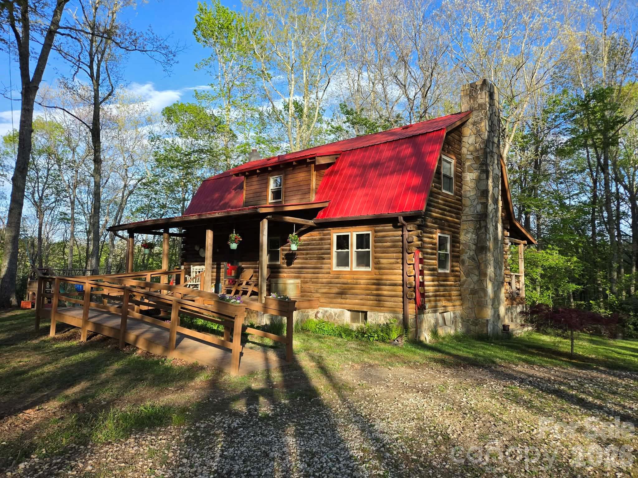 Beautiful log home with mountain views set back in the woods on just over 3 acres. The home has 3 bedrooms upstairs with a full bath, and a fully finished basement with a bedroom, a full kitchen, an outdoor entrance, and a full bath. Located in the basement are the laundry room, a freezer room with an included chest freezer, and a root cellar for cool storage. The kitchen and basement both have wood cook stoves. The living room has a wood stove for heating. There are also oil-fired monitor heaters in the living room, kitchen/dining area, and in the basement. The home is on great-tasting well water that is shared with another smaller home. Water rights will be included with the home.