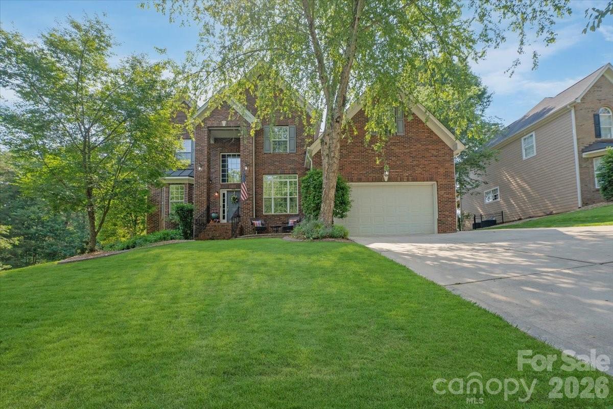 Located along the 13th hole in the highly sought-after Tega Cay golf course community, this beautifully updated 5-bedroom, 3.5-bath home offers the perfect blend of comfort, style, and location. Thoughtfully maintained and move-in ready, the home features recent upgrades including a fully renovated kitchen, stunning primary bath remodel, custom woodwork and marble around the fireplace, new upstairs carpet in the main areas, new roof and newer HVAC and furnace systems for added peace of mind.

The spacious floor plan provides room for both everyday living and entertaining, while large windows showcase golf course views and bring in abundant natural light. The updated kitchen serves as the heart of the home with modern finishes, ample storage, and inviting gathering spaces nearby. The main-level primary suite offers convenience and comfort with a beautifully redesigned spa-like bathroom, creating the perfect private retreat. Upstairs, additional bedrooms provide flexible space for guests, hobbies, or home office needs.

Step outside and enjoy the expansive deck — perfect for entertaining, outdoor dining, or simply relaxing while taking in the beautiful golf course setting. The adjacent common area, currently maintained by the owner, enhances the sense of space and privacy rarely found. Whether hosting gatherings or enjoying a quiet evening outdoors, this home offers exceptional indoor and outdoor living opportunities.

Living in Tega Cay means access to outstanding community amenities including golf, tennis, pickleball, pools, parks, walking trails, lake access, and a vibrant social atmosphere. Conveniently located just minutes from shopping, dining, and top-rated schools, with an easy commute to Charlotte, this home combines lifestyle rich living with everyday convenience.