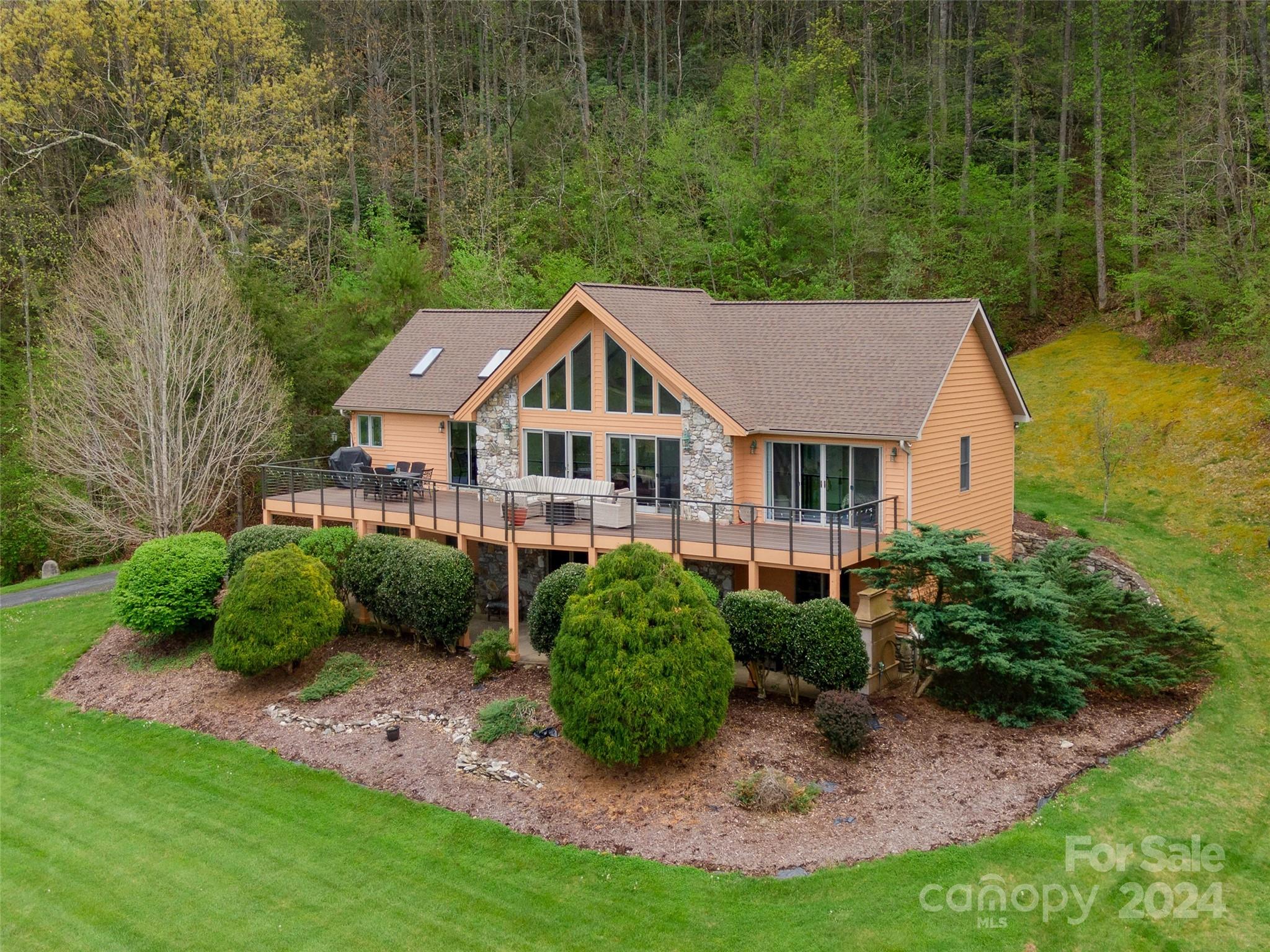 Home remodeled with new kitchen, baths and updated bedrooms. Great room with engineered stacked stone fireplace, cedar mantel and custom bookshelves of wood from the property. Kitchen renovated with quartz counter tops, new backsplash, custom cabinets, new flooring and stainless Jenn-Air appliances. Main Level, Primary bedroom, jet tub, new flooring, and access to deck. Second bedroom or study or office with murphy bed and full bath. Lower level with 2 bedrooms, full bath, family/recreation room with fireplace, double garage and storage area. Home has double carport at door on mail level and long-range mountain views across protected conservation agricultural fields. New Roof 2024, HVAC 2017, tankless water heater, Trex deck, and cedar-siding. See Features sheet.