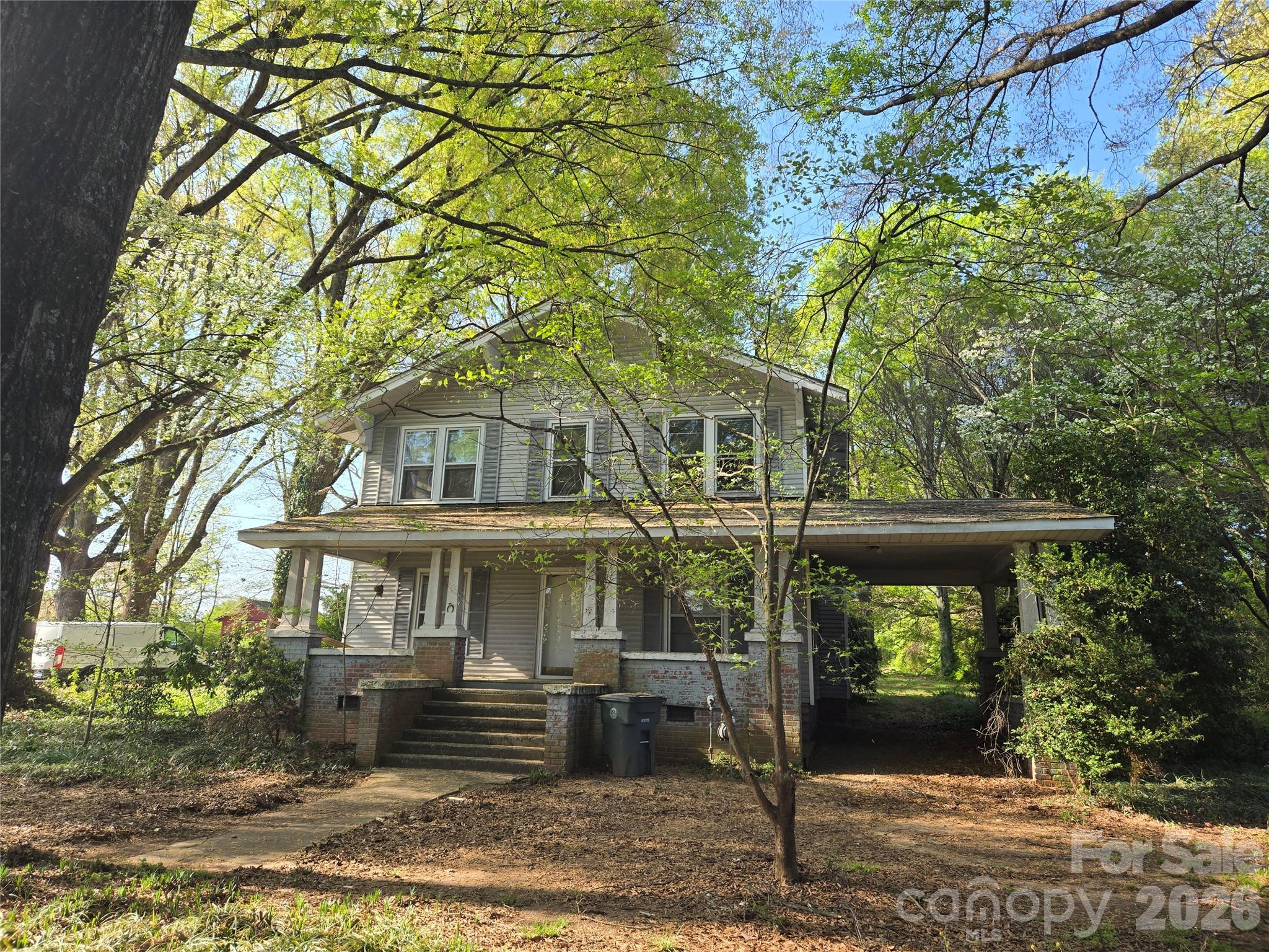 HERE IT IS! That affordable, turn of the century "Diamond in the rough" farm style home you have been looking for! The home is broom swept clean and is ready for updates to fit your taste. This charming older 2 story farm house with a porte cochere sits on a .95 acre lot with lots of space both inside and out, with those oversized rooms that are characteristic of a home of this age and a large covered rocking chair front porch.  Ready to make it your own,  the home's 1st floor features 10 ft ceilings, original hardwood floors (except in the kitchen and bath) a large living room with a gas fireplace (no gas logs present), a parlor with 9 lite french doors and built-ins that is perfect for a den, office or whatever fits your needs.  Off the living room is a dining room; again w/10ft ceilings, hardwood floors and built in china cabinet and an oversized kitchen.  At the rear of the main level is a smaller bedroom with attached bath that opens into the rear entry hall. The rear entry to the home is through an oversized laundry/mud room that open up to the large back yard. Off the living room and in the rear hall is a grand style staircase leading to the enormous hallway upstairs where you will find four good sized bedrooms (one does not have a closet but this was typical with the age of the home) all with hardwood floors, a central hall bath and pull down attic access. The home also features a partial cellar with access from both the interior of the home (In the back hall) and outside. The home sits on a large near acre lot with out-building. The right side of the property backs up to property that is currently zoned for office space.  The county would not confirm if zoning could be changed on this property for like use without applying for a zoning change request. This would be the responsibility of the buyer and/or their agent. Please note: The seller is selling the home as is/where is with no repairs. The home has been empty for some time. It is unknown if the kitchen appliances are working properly.  AC unit is not working due to damage during a storm.  There has been seepage in cellar/crawl space during heavy rains in the past, but a sump pump has been installed.  Possible knob and spool electric visible in cellar. Home will not qualify for any most Government backed financing. May qualify for FHA 203K rehabilitation loan, but buyer should verify with their lender before making an offer.