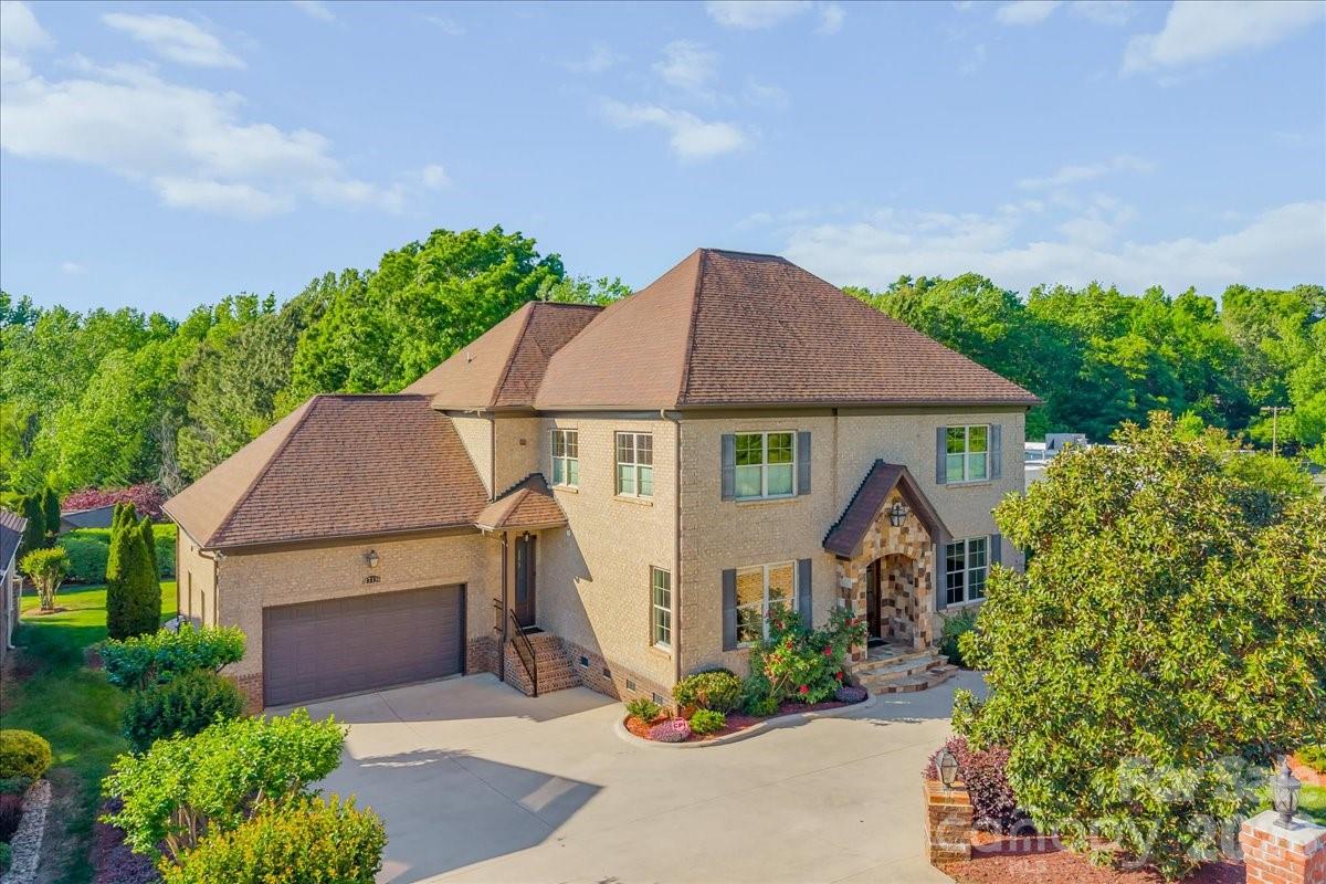 Welcome to one of Ballantyne’s most unique and versatile luxury opportunities, two custom homes seamlessly brought together under one roof.

Designed for flexibility and elevated living, this full brick estate offers the perfect solution for multi generational households, private guest accommodations, or income producing potential. Originally built as two separate custom residences of approximately 2,500 square feet each, both with private entrances, the home delivers unmatched adaptability while maintaining a cohesive and refined feel.

Each level lives like its own residence, complete with full kitchens, spacious living areas, primary suites, and dedicated laundry, creating independence without sacrificing connection. There is also an easy opportunity to open and fully connect both sides if desired, with original builder plans available. The main level showcases refined everyday living with rich hardwoods, curated finishes, an open layout, office, flex space, and elegant entertaining areas. The chef’s kitchen features custom lighting and detailed finishes, flowing into inviting living spaces anchored by a fireplace.

The upper level expands the possibilities with its own bonus room and a complete second living environment, ideal for extended family or rental use. At the entrance, there is a 1/2 bath and flex space/mudroom on the main level before going up the stairs. Once in the living area, thoughtful details elevate the home throughout, including fireplace, a wet bar, walk in closets, and a spa inspired primary suite with a vaulted ceiling, oversized shower, and garden tub.

Step outside to enjoy layered outdoor living with covered porches, terrace spaces, a private deck, and a fire pit designed for gathering and relaxation. The beautifully maintained grounds are supported by an in ground irrigation system, with ample space for a future pool or outdoor kitchen.

With garage capacity, additional parking, and a beautifully manicured lot, this property offers rare scale, flexibility, and long term value in one of Charlotte’s most sought after areas, just minutes from Ballantyne’s premier shopping, dining, and top rated schools.