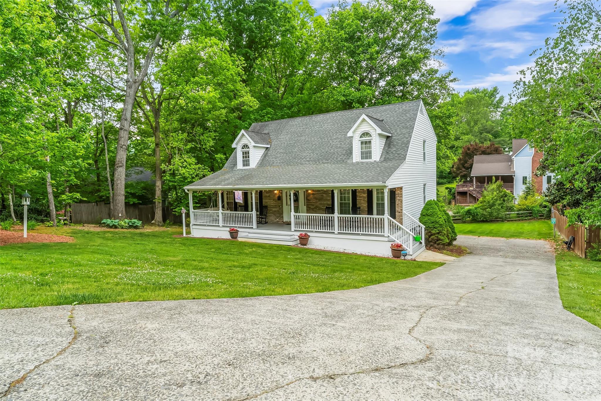 Set on a beautifully level and meticulously maintained 0.37-acre lot, this exceptional 4BR/3BA home offers the perfect blend of timeless character, generous living spaces, and thoughtful modern updates. From the moment you arrive, the inviting curb appeal and evident pride of ownership create an immediate sense of warmth and home.

Inside, the main level is designed for both everyday comfort and effortless entertaining. A welcoming living room with a gas log fireplace provides the perfect gathering space, while the formal dining room adds classic charm for holidays and special occasions. The remodeled kitchen is truly the heart of the home—featuring updated appliances, abundant counter space, and seamless flow into a cozy secondary living area anchored by a stunning wood-burning fireplace. A spacious main-level bedroom and beautifully updated full bath with a luxurious walk-in tile shower offer ideal flexibility for guests or multigenerational living.

Upstairs, the expansive primary suite feels like a private retreat, complete with a walk-in closet and a spa-inspired en suite bath featuring a soaking tub, dual vanity, and exceptional storage. Two additional bedrooms share a convenient Jack-and-Jill bath, creating a functional and comfortable layout for family or visitors alike.

The finished basement adds even more versatility, providing the perfect space for a media room, recreation area, home office, or playroom. Outside, the rear deck overlooks a lush, usable backyard—ideal for relaxing evenings, gardening, play, or entertaining under the trees.

Every inch of this home reflects careful stewardship and quality investment. Significant improvements include a $30K chimney renovation with new wood-burning fireplace, interior painting throughout, updated flooring, new carpet, modernized stairs and railing, new garage door, painted front porch, and a beautifully renovated bathroom with upscale finishes.

Ideally located with convenient access to the interstate, shopping, dining, and just under 20 minutes to downtown Asheville, this home offers both tranquility and convenience. Per seller, the property has experienced no flooding during 30 years of ownership, including during Helene. It is NOT located in a flood zone.

Lovingly cared for and filled with decades of treasured memories, this remarkable property is ready to welcome its next chapter—and its next owners—home.