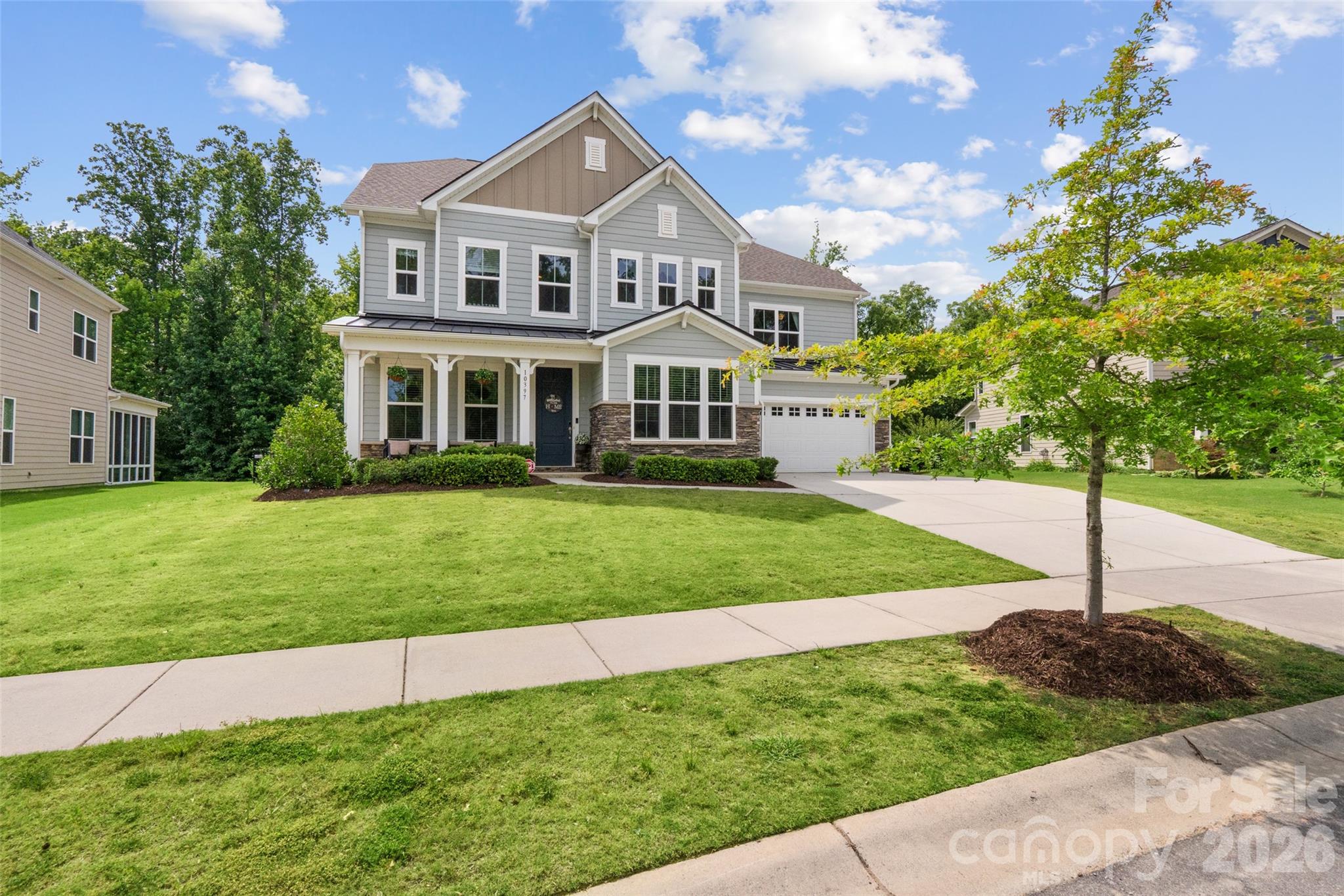 Rare opportunity to own a Taylor Morrison-built home in Holcomb Woods, situated on a nearly half-acre lot backing to Reedy Creek Nature Preserve, this exceptional property offers over 3,700 square feet of thoughtfully designed living space, including a highly desirable main-level primary suite.
Designed for both everyday living and effortless entertaining, the open-concept floor plan centers around a chef’s kitchen featuring a large island with seating, butler’s pantry, walk-in pantry, abundant cabinetry, and seamless flow into the spacious great room.
The private primary suite serves as a true retreat, complete with dual vanities, a soaking tub, separate shower, and oversized walk-in closet. A flexible main-level room provides the perfect space for a home office, study, or sitting area.
Upstairs, you’ll find three generously sized secondary bedrooms, including one with an ensuite bath, all with walk-in closets. A versatile loft, two full bathrooms, and an impressive walk-in attic provide exceptional flexibility and storage.
Timeless curb appeal is showcased through stone, brick, and fiber-cement accents, while covered front and rear porches create inviting outdoor living spaces. The fenced backyard backs directly to Reedy Creek Nature Preserve, offering a rare combination of privacy and peaceful wooded views. Enjoy evenings around the firepit, outdoor dining, or simply relaxing while taking in the natural surroundings.
Located in a highly rated school district and just minutes from shopping, dining, and everyday conveniences, this home perfectly balances luxury, privacy, and convenience. With the community pool just a short stroll away, you’ll enjoy resort-style amenities while still having your own private retreat.