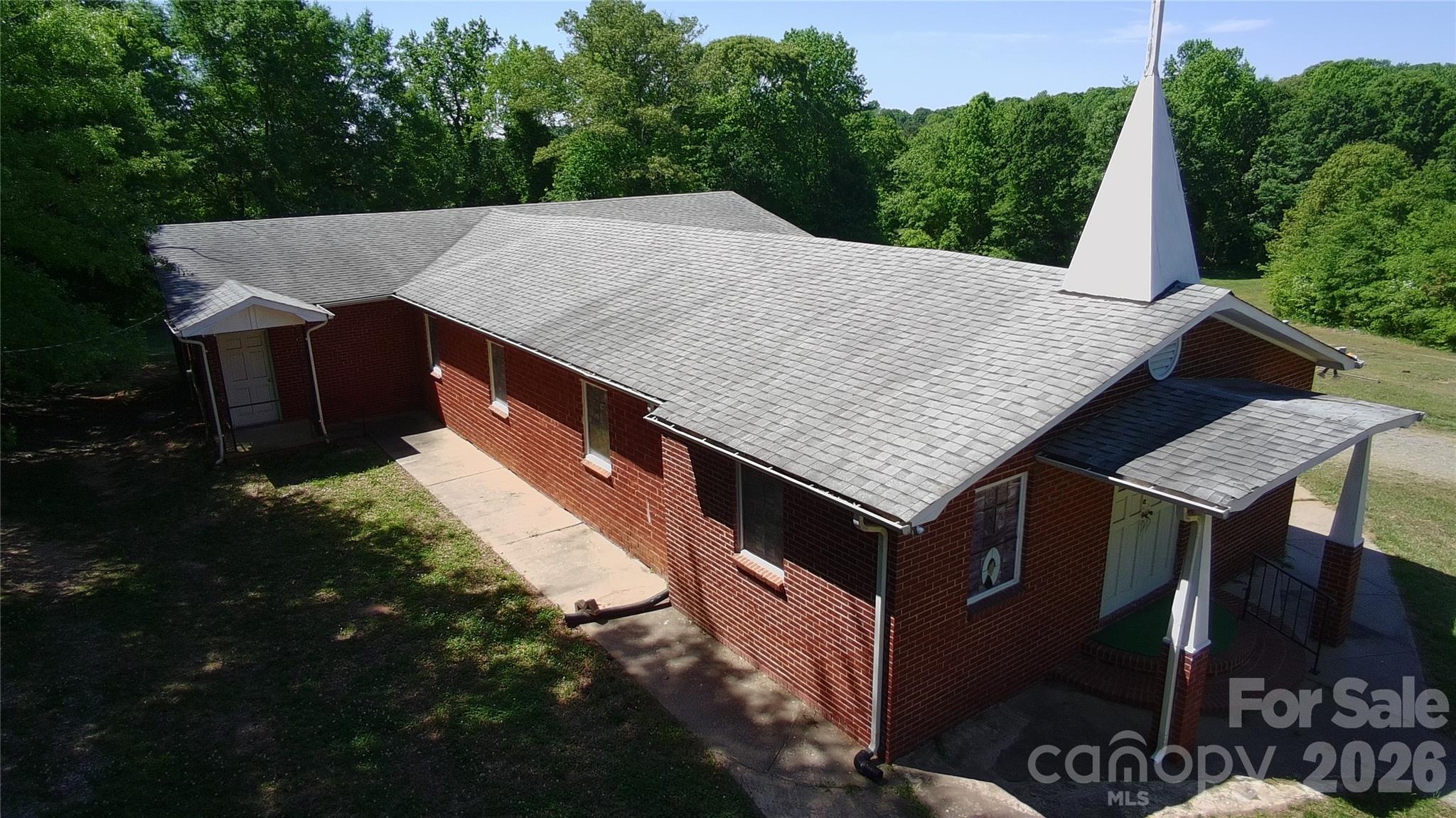 Great versatile church building with potential for upgrading or possible other use. The current sanctuary comes with 26 pews, A/V equipment, and baptism pool. Additional spaces include 4 bathrooms, kitchen, and 2 offices. The exterior features a ramp for easy access and plenty of spaces for parking on the ¾ acre lot. The cemetery next door is on a different lot and not included in the sale.