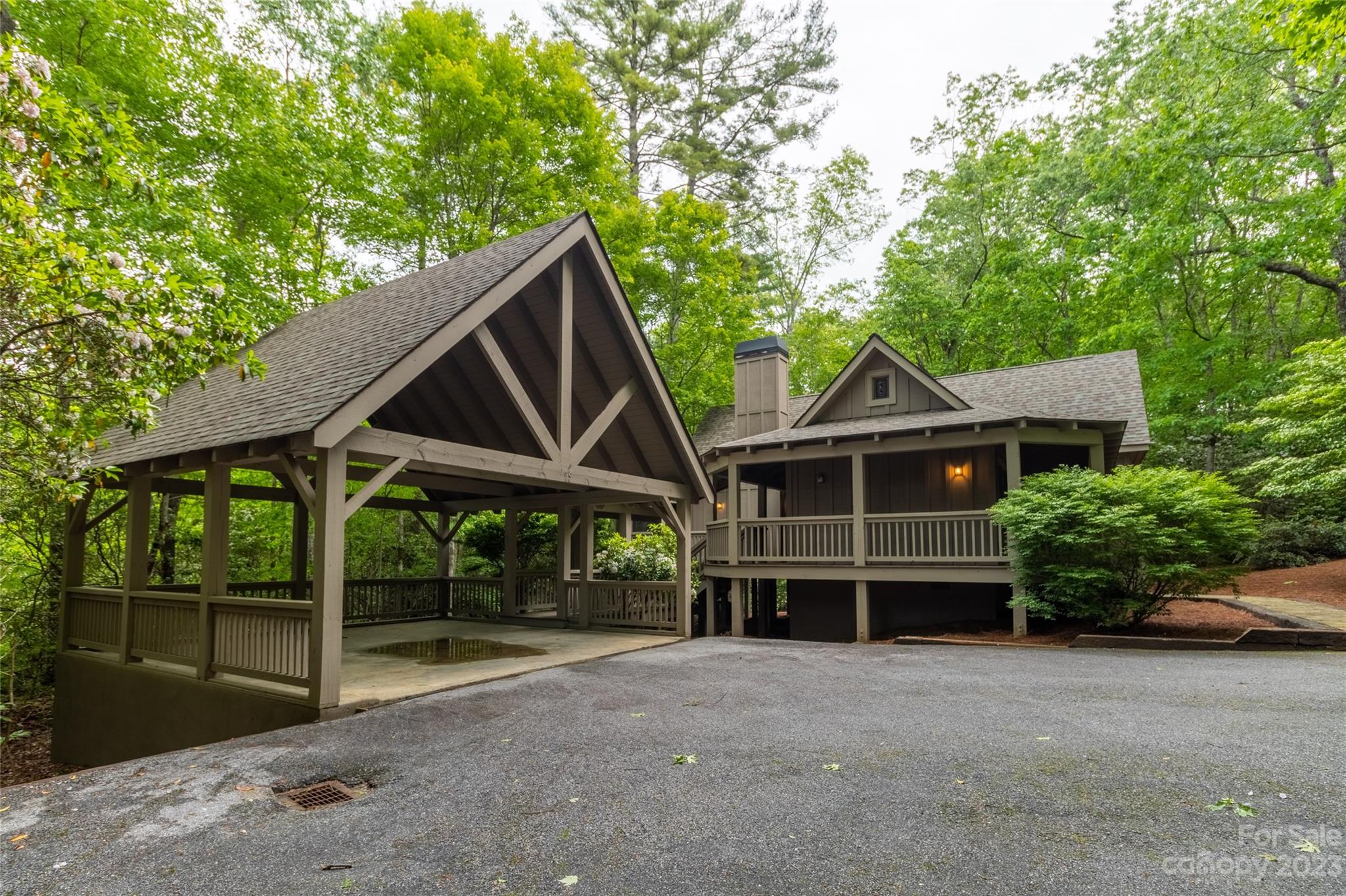This home could not be cuter! It's that quintessential cabin in the woods, at the end of the cul de sac, nestled in the woods and extremely private. Yet, it's located in the upscale Burlingame Community. There is nothing even remotely comparable for the price! Two-bedroom suites frame the great room with a rustic dry-stack stone fireplace! Plus, a loft overlooks the great room that can be used as a studio or den. There's a screened porch, wraparound covered decks, and a rocking chair front porch. A covered breezeway provides access to the double carport and a driveway with plenty of extra parking.