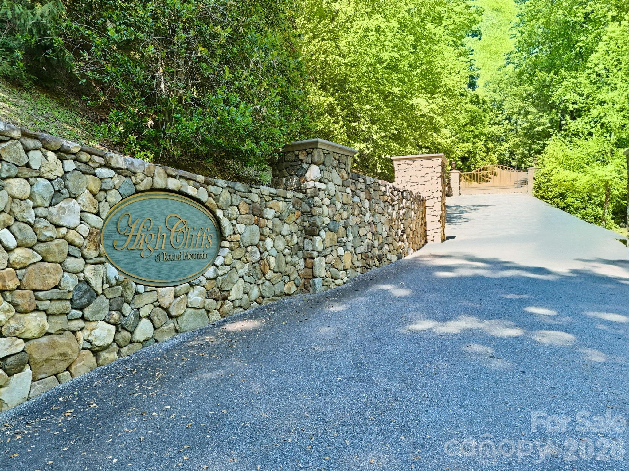 Tucked into the private, gated community of High Cliffs at Round Mountain, this 13.11-acre wooded lot offers serious long-range mountain view potential once cleared. Perched above Black Mountain, the land sits within an exclusive community where luxury homes are designed to blend with the natural landscape, and the setting lives up to that promise. Just 15 minutes to the charming town of Black Mountain and 10 minutes to the historic railroad community of Old Fort, with Chimney Rock and Lake Lure also within easy reach. This is Western North Carolina mountain living with real convenience attached. Additional Community Information can be found at the community website