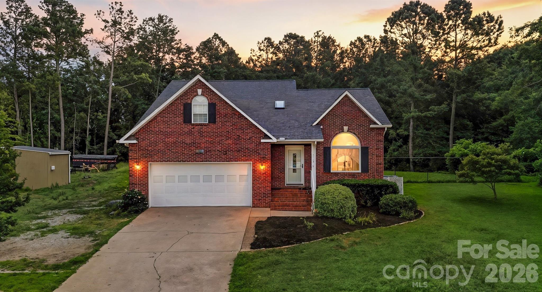 This beautifully updated & well maintained 3BR, 2.5 bath traditional brick home offers 1,675 sq ft of comfortable living, filled with natural light throughout. The main level features a spacious primary suite with a walk-in closet & en-suite bath. The vaulted living room showcases a stunning electric fireplace with plenty of open space. The kitchen is a standout with granite countertops & a newer stove, blending style & functionality for those home cooked meals. Upstairs, a large finished bonus room offers flexible space for a home office, media room or playroom. 2 BRs & a bathroom complete this spacious upper level. Enjoy the outdoors with lake views from the front porch or the large fenced backyard with a large deck ideal for entertaining. Additional features include newer windows, doors, walk-in closets & 2-car garage. Located minutes from Lake Hickory Scuba & Marina.