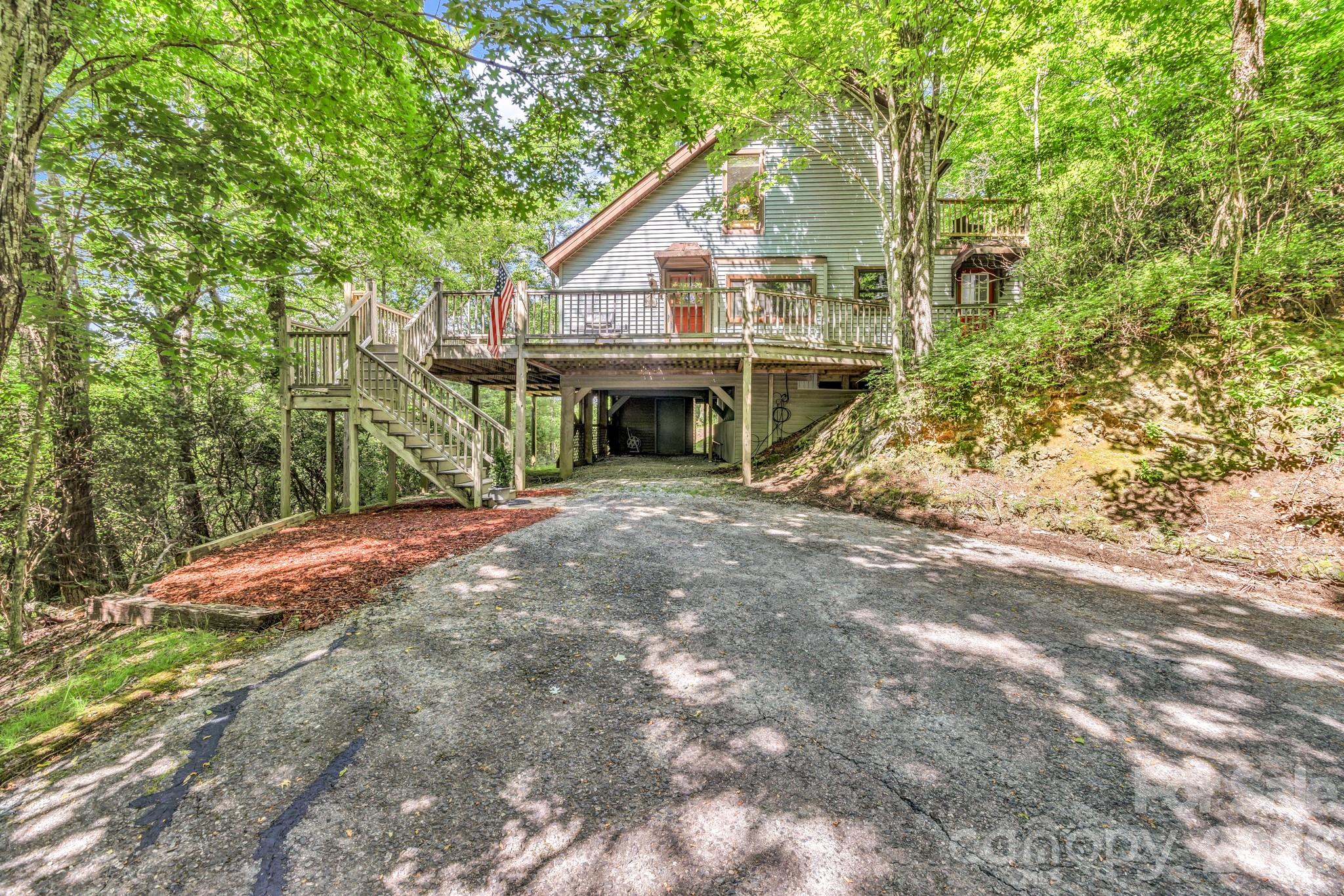 Welcome to 571 Tsisqua Circle, a mountain home tucked among the trees in the highly sought-after Connestee Falls community of Brevard. Situated on approximately 0.6 acres, this 3-bedroom, 2-bath home offers a peaceful setting, seasonal mountain views, and easy access to the outdoor amenities that make Connestee Falls one of Western North Carolina’s premier gated communities.

Inside, you’ll find a comfortable layout with main-level living, including a primary bedroom, full bath, and convenient laundry area. The living room is anchored by a wood-burning fireplace, creating a warm gathering space during the cooler months. Large windows bring in natural light, while the expansive deck provides plenty of room to relax, entertain, or simply enjoy the wooded surroundings.

Recent improvements provide added value and peace of mind, including a roof replaced in 2019, new washer, dryer, microwave, and stove installed in 2022, replacement windows added in 2023, and new insulation installed beneath much of the home in 2023.

Living in Connestee Falls means access to an impressive collection of amenities, including four private lakes, miles of hiking trails, multiple waterfalls, tennis and pickleball courts, a swimming pool, wellness center, clubhouse, and an 18-hole championship golf course. Whether you’re looking for a full-time residence, seasonal getaway, or mountain retreat, this property offers the opportunity to enjoy the best of mountain living while being just minutes from downtown Brevard, Pisgah National Forest, and countless outdoor recreation opportunities.