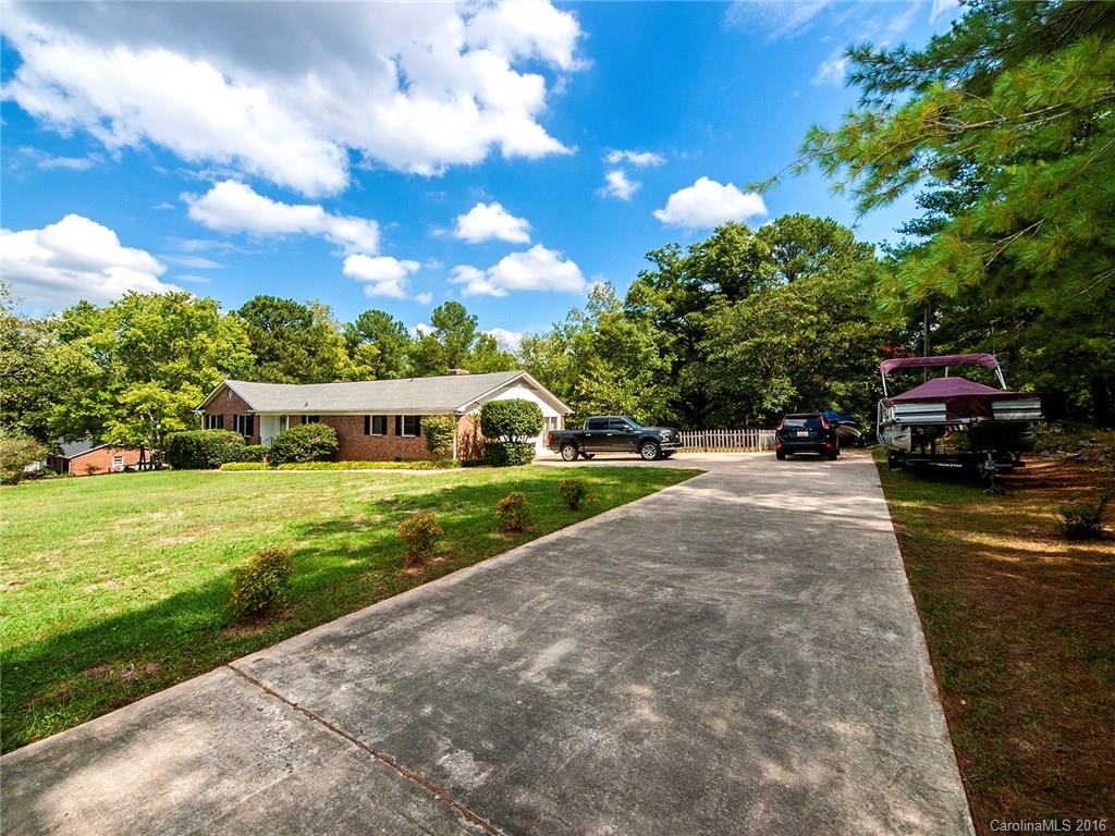 Enjoy country living with easy access to I-77! A nature lover's dream!  Here, there is more than meets the eye.  This home has tons of storage, large rooms, two deep wells with water filtration, backyard irrigation with six points of access, and an over-sized brick garage/shop detached from the home.  Relax on the large covered deck overlooking a private wooded back yard.  This home has two parcels making up approx. 4.11 acres 6850000044 and 6850000064.  Low SC taxes.