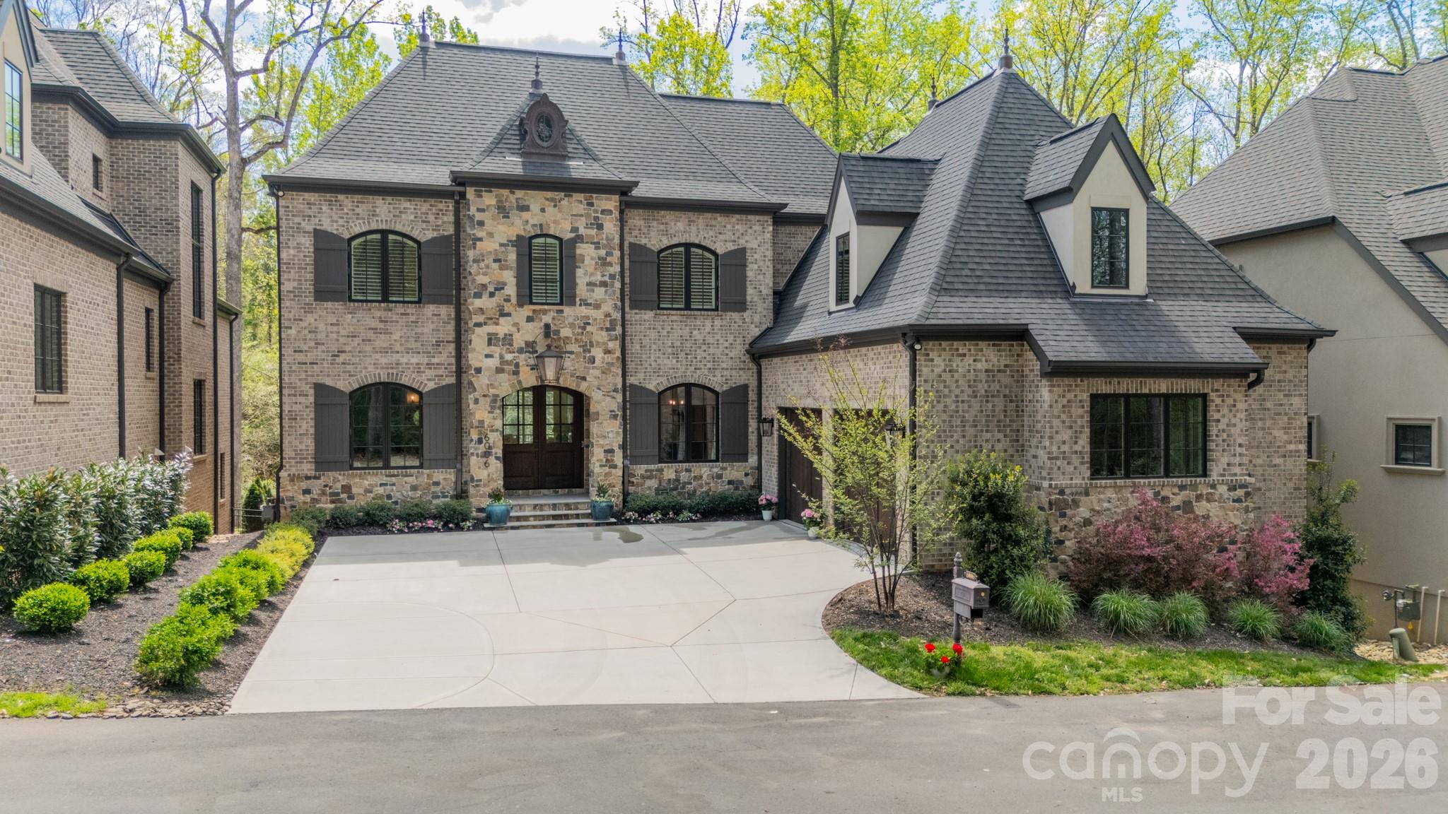 Tucked on a private street just off of Old Providence Rd., Old Providence Lane is a beautifully designed and thoughtfully crafted. This exceptional home blends luxury with everyday livability. The chef’s kitchen is a true centerpiece, featuring premium Thermador appliances, a spacious walk-in pantry, and high-end designer finishes. Rich hardwood floors flow throughout the home, complemented by soaring ceilings and an abundance of natural light that highlights the private, serene views from both the front and back.
The main level offers a versatile guest bedroom or office, while the inviting great room opens seamlessly to a screened porch—perfect for indoor-outdoor living. Upstairs, the stunning primary suite serves as a private retreat, complete with a generous walk-in closet and spa-like feel.
The fully finished basement provides a large entertainment space ideal for gatherings, movie nights, or recreation. Designed with future convenience in mind, the home includes a built-in shaft for a potential elevator. An additional upstairs room offers flexibility as a fourth bedroom with a private bath or a secluded office with its own den.
This home effortlessly combines elegance, comfort, and functionality in every detail.