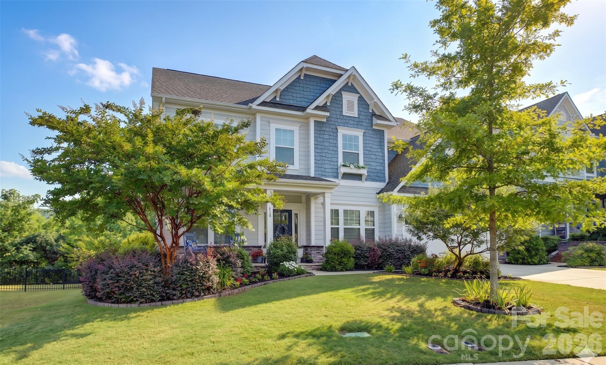 Located in the gated Pinnacle at Handsmill—one of Lake Wylie’s most sought-after communities—this exceptional home offers timeless Southern charm paired with modern luxury, all within the award-winning Clover School District. A classic rocking-chair front porch welcomes you into a beautifully curated floor plan featuring a private French-door study with coffered ceilings, positioned just off the foyer and across from the formal dining room. A convenient pass-through butler’s pantry connects to the heart of the home, making entertaining seamless.
The chef’s kitchen is the centerpiece, showcasing a gas cooktop, double wall ovens, an oversized island with bar seating and a single-bowl sink, and abundant crisp white cabinetry. The kitchen opens to a sunlit breakfast area with views of the covered rear patio, extended outdoor living space, an expansive backyard, and a dedicated garden area—perfect for the home gardener.
The spacious great room is filled with natural light from oversized windows and anchored by a warm gas fireplace. A main-level guest suite with a full bath provides ideal accommodations for visitors.
Upstairs, the primary retreat offers a spa-inspired bath with dual vanities, a soaking tub, and a glass-enclosed shower with a rain showerhead. Three additional bedrooms, two full baths, and a flexible bed/bonus room provide endless options for family living, guests, a playroom, or work-from-home space.
Handsmill residents enjoy resort-style amenities including a clubhouse, pool, fitness center, walking trails, and a marina with wet slips and dry storage (available for lease, subject to availability)—delivering the perfect balance of comfort, lifestyle, and lakeside living.
This home will be measured on Thursday, the 28th. Current measurements are from the York County property tax roll