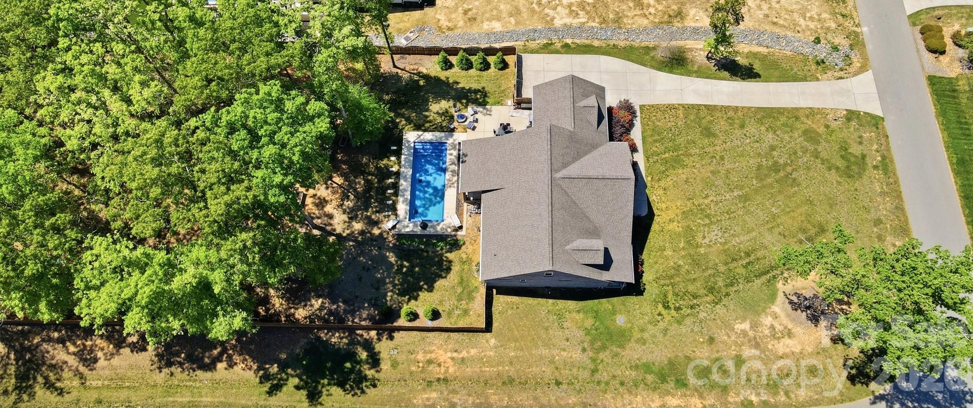 Stunning Custom Home in a Highly Sought-After Union County Community
Welcome to this exceptional, upgraded home offering the perfect blend of luxury, comfort, and functionality—all in the heart of Union County.

Step inside to an open-concept floor plan designed for modern living and effortless entertaining. The chef’s kitchen is a true centerpiece, featuring a massive island with breakfast bar seating, elegant pendant lighting, quartz countertops, stainless steel appliances, a gas range with double oven, custom tile backsplash, and an oversized custom pantry.

The kitchen flows seamlessly into a spacious living room anchored by a striking stone fireplace, while the formal dining area overlooks your private backyard retreat—ideal for gatherings both large and small.

The expansive primary suite offers a versatile bonus nook, perfect for a home office, reading area, or fitness space. The luxurious en-suite bath includes a beautifully tiled shower, dual vanities, and a large closet.

Additional features include two generously sized bedrooms with a full bath, plus a flexible fourth bedroom or 2nd Primary Bedroom is complete with its own en-suite bathroom and closet—perfect for guests or multi-generational living.

Save the Best for Last - outside to your personal backyard oasis. Enjoy a covered patio and open courtyard space with Firepit connected to the gas line. Unwind in the stunning saltwater pool with outdoor shower. The fully fenced yard extends deep into a wooded backdrop, offering both privacy and natural beauty.

Additional highlights include attic access from the garage with excellent potential for future expansion. Oversized 2 Car Garage with Side door to the Back Patio

Located in a prime area within the desirable Piedmont school district, this home truly has it all.
