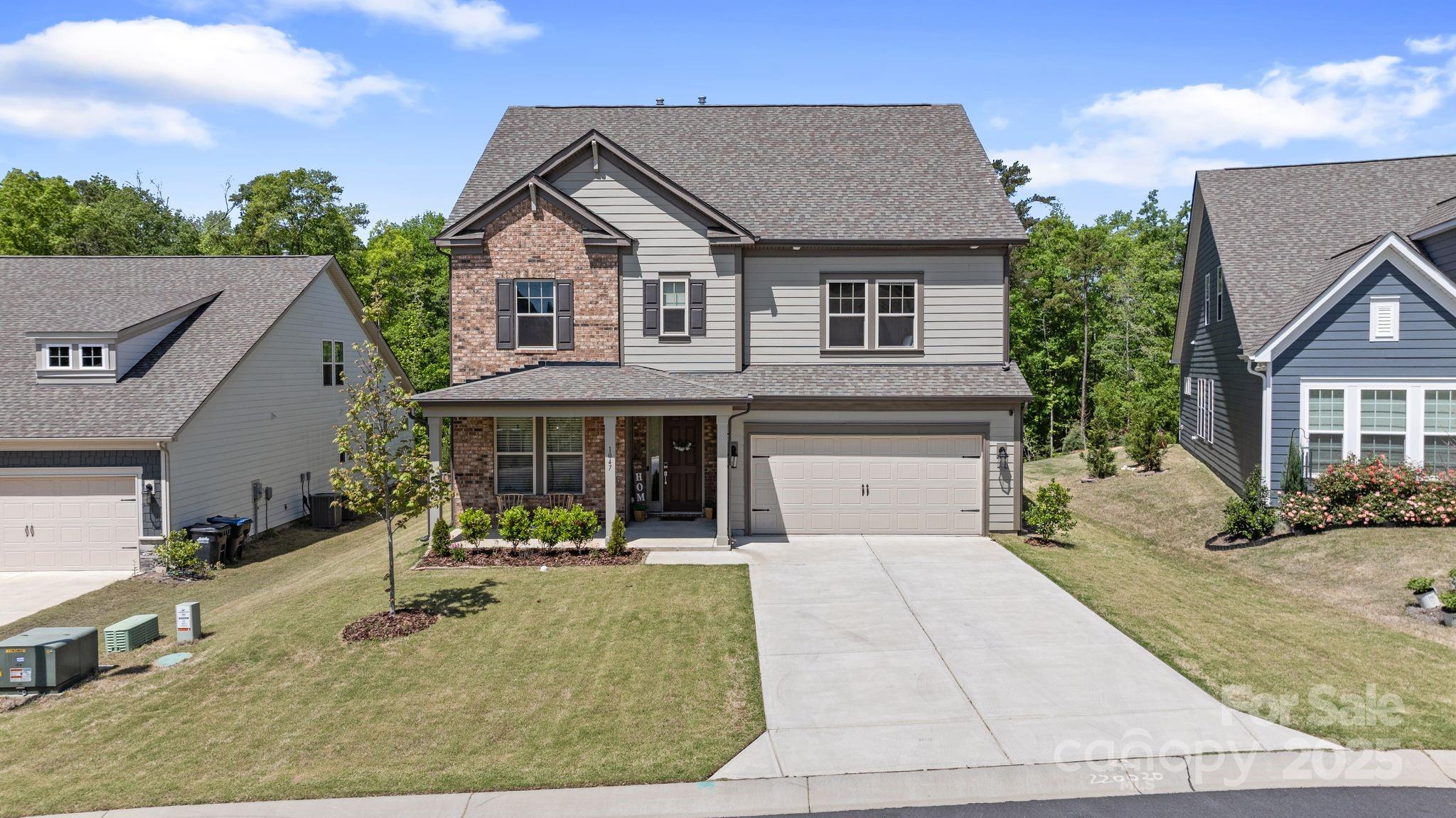 Welcome to this bright, better-than-new Taylor Morrison home in Indian Land, just minutes from Ballantyne. Thoughtfully designed for comfort, the open-concept first floor is filled with natural light and flows from the living room to the kitchen, breakfast area, sunroom, and formal dining room.
The gourmet kitchen features a gas range, double oven, oversized island, walk-in pantry, and a butler’s pantry that can easily be a great coffee bar. 
A main-level guest suite with full bath and walk-in shower is ideal for visitors. Off the two-car garage, a drop zone keeps essentials organized.
Enjoy morning coffee or quiet evenings in the sunroom or on the extended composite deck—both offering peaceful wooded views and abundant sunlight.
Upstairs, the owner’s retreat spans the back of the home with two walk-in closets, double vanities, a soaking tub, and a large walk-in shower. Three more bedrooms, a Jack-and-Jill bath, laundry room, and loft complete the second floor.