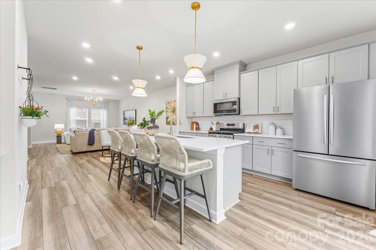 $6500 lender-paid credit to qualified buyers who use the seller's preferred lender! MOVE-IN READY & meticulously maintained townhome in the highly desirable, WALKABLE NEIGHBORHOOD of City Park! 

Park your car and stroll to local favorites like the Regional Farmers Market, Starbucks, Panera, and Chipotle, along with Renaissance Park, which features ball fields, a sand volleyball court, a skate park, a dog park, and disc golf. With quick access to I-77, you're just minutes away from Uptown, LoSo, South End, and Charlotte Regional Airport. 

This townhome boasts an open, split bedroom floor plan with upgraded lighting, arched mirrors and a beautiful kitchen featuring a gas range and an oversized quartz island—perfect for entertaining! The first-floor bedroom/office has an ensuite bathroom, making it ideal for guests or as an excellent work-from-home space. Upstairs, enjoy a generous primary suite, two additional bedrooms, and a full bath. 

This unit stands apart from other available units by offering immediate access to additional parking and community amenities just steps away, including cornhole, a fire pit, built-in grills, and picnic tables.

Lastly, an attached two-car garage, UPS store coming soon and trail access to the Sugar Creek Greenway, coming 2026-2027. Built by Mertiage homes who is nationally recognized for delivering thoughtful design that promotes lower energy use, improved indoor air quality, and year-round comfort.