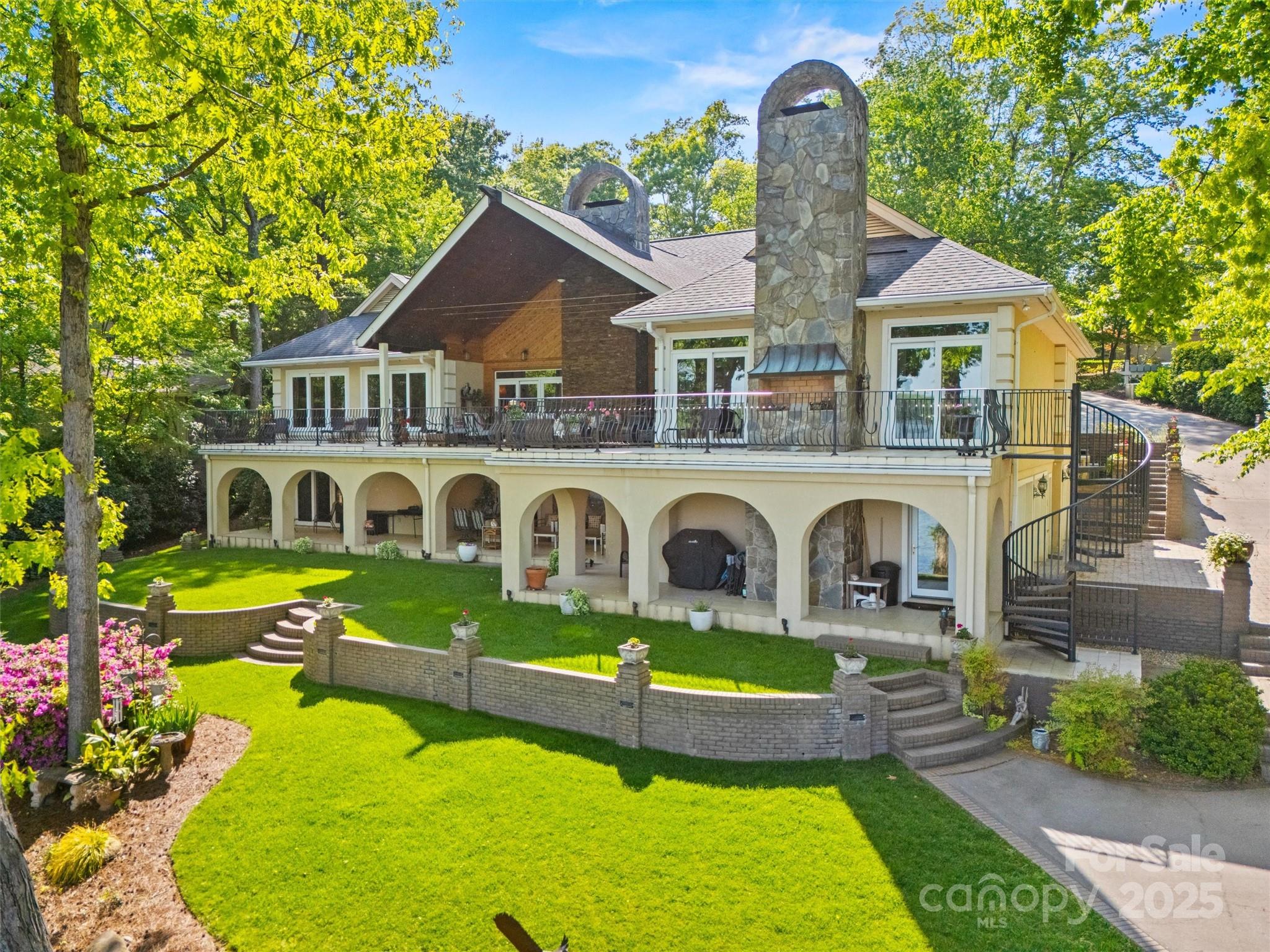 PRICED TO SELL in time for summertime. BRING US AN OFFER.Welcome home to this elegant waterfront estate with phenomenal views!outdoor living that is amazing & 1 of a kind on Lake Wylie & within the gated community of River Hills.Huge covered deck extends the length of the home upstairs w/ views every direction &patios span the length downstairs.Beautiful green lawn & tiered terraces/retaining walls in backyard finish down to the waterfront w/dock that has covered seating space for dining alfresco plus floating dock & lift.The interior of this one is stunning as well with large living spaces but cozy feel.Oversized great room w/ doors to the lake,3 person elevator for easy trips from garage,the study has amazing detail & offers hand carved bar for entertaining,dining room w/seating for up to 20 if needed,oversized island and tons of counter space and subzero appliances in kitchen/eat in, primary suite on main floor w/true spa like & additional bedroom w/ensuite bath complete this floor