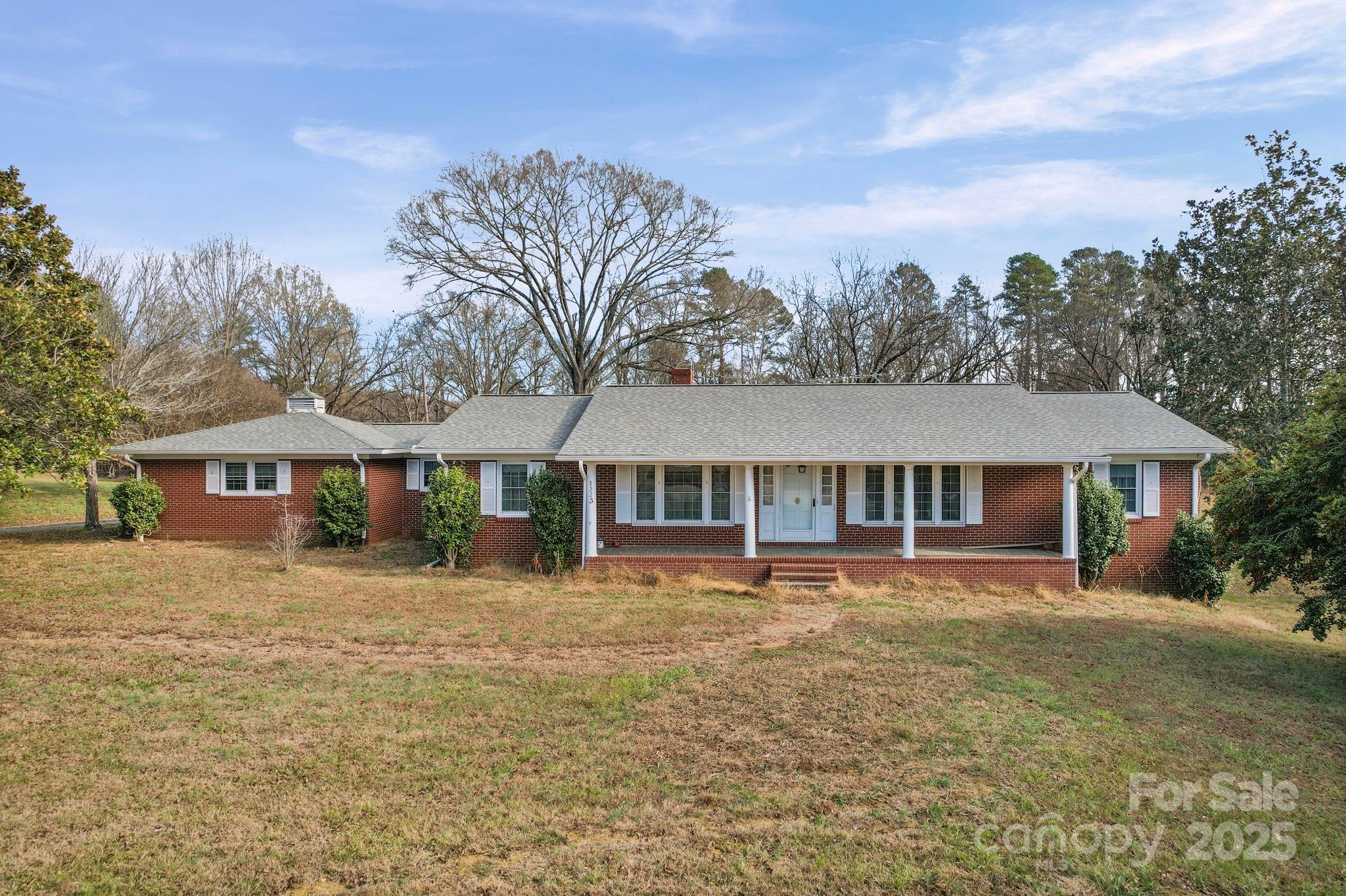 Step back in time with this classic, full-brick home sitting on 5.87 private acres—with the huge bonus of no city taxes! This well built home is ready for your vision, as it does need TLC and updating to restore it's beauty again.  The finished walk-out basement is a significant asset, while not heated or cooled, presents an opportunity to double your living space. Outdoors you’ll find a brick fenced in-ground pool, lots of open space, and shade from abundant mature pecan trees. The property also includes excellent storage and workspace, boasting a separate workshop, a large covered open-air building perfect for all types of equipment, and a smaller covered shed. This is a great opportunity to own the American dream with room to grow and customize every detail to your specifications.  The measured heated living area for this home is 2571 square feet.  The sunroom and laundry room are a combined 537 square feet. They are included in the total heated living area, but are not permitted.  The 1454 square foot basement is finished with full bath but is not heated or permitted. Home is being sold AS IS with no repairs.  A 30 acre tract just north of this property has been approved for a 60 lot subdivision.  See map in attachments.