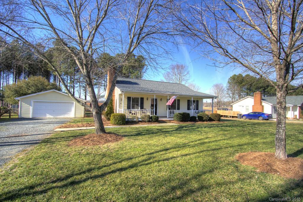 Rocking chair front porch welcomes you to this move-in-ready ranch on 1/2 acre lot.  new roof in fall 2014, new water heater.  GR with Vaulted ceiling, masonry FP.  Kitchen w/tile floor, stove replaced, new hardware on cabinets, nice master w/his & hers closets and private master bath.  Oversized deck, fenced yard, oversized detached 2 car garage.
