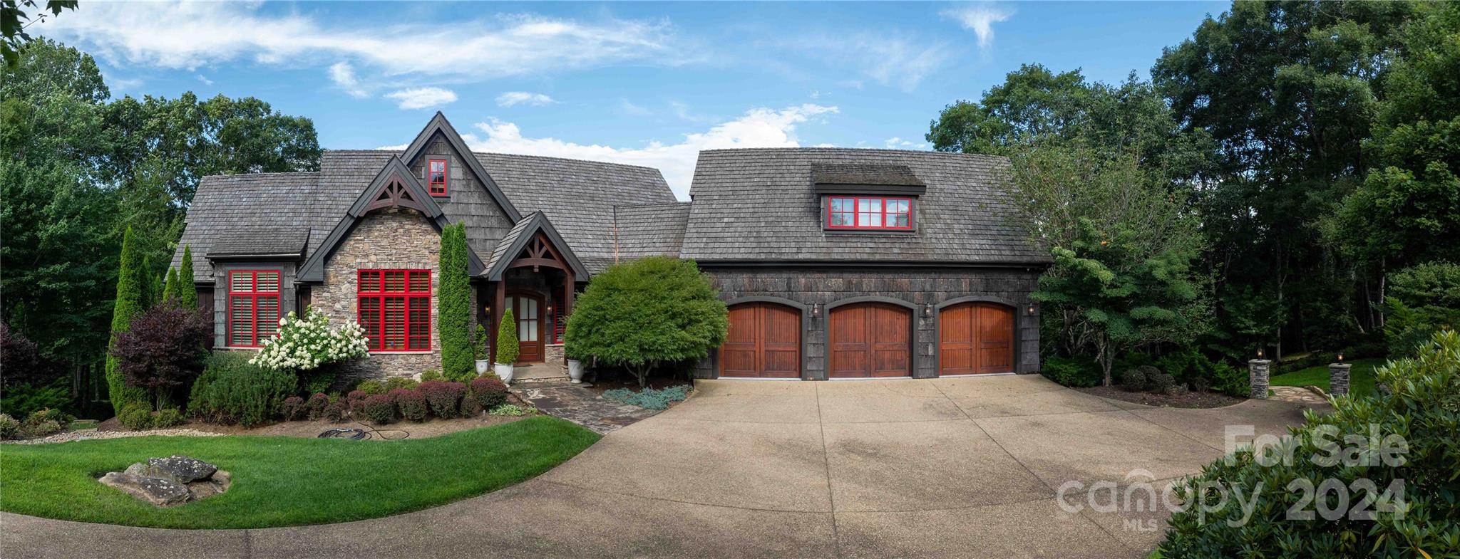 This custom-built High Country home combines rustic charm with modern luxury. Set on 2.40 acres, it features 4 bedrooms, 4 full baths, 2 half baths. The exterior showcases stone and poplar bark, while the interior boasts extensive woodwork, coffered ceilings, and three indoor stone fireplaces. Enjoy multiple decks, two outdoor fireplaces, and an elevator serving all floors.

Amenities include a central vacuum, sound and security systems, whole-house water filter, climate control, and a heated three-car garage. The gourmet kitchen with Sub-Zero and Wolf appliances, a large island, and a copper sink opens to a breakfast area. The living and dining rooms offer stunning views of Grandfather Mountain.

The primary suite features a private deck, study, two walk-in closets, and a luxurious bathroom with heated floors, a tub, and a walk-in shower. The lower level includes a great room with a full bar, three additional bedrooms, 2.5 baths, and a 51x21 wine cellar with extensive storage.