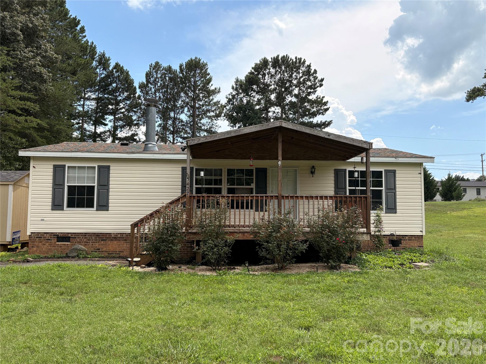 Welcome home to comfort and simplicity! This charming 1,075 sq. ft. manufactured double-wide sits on approximately .47 acres and offers the perfect blend of cozy living and functional space. Enjoy relaxing mornings or peaceful evenings on the spacious front deck, ideal for entertaining or simply unwinding at home.

Inside, you’ll find a warm and inviting atmosphere that makes this home perfect for first-time buyers, those looking to downsize, or anyone searching for a place that truly feels like home. The property also includes a storage shed for added convenience and extra space.

The kitchen comes equipped with a stove, refrigerator, and microwave, making move-in easy and stress-free. With its homey feel, comfortable layout, and generous outdoor space, this property is ready to welcome its next owner!