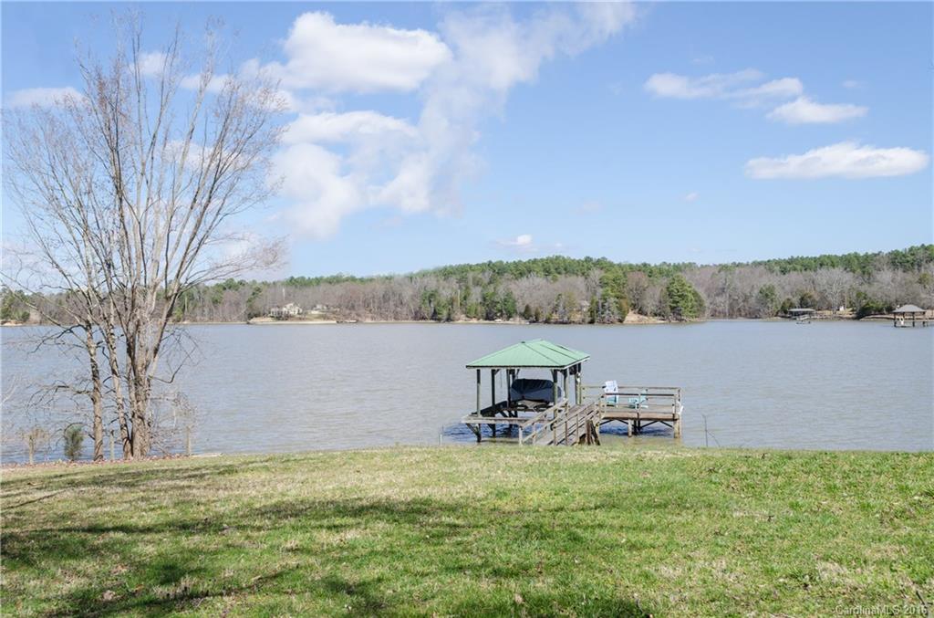The perfect lake retreat! Soaring cathedral ceilings with exposed beams, hardwood floors, and the authentic feel of a lake house! You'll fall in love with the big open views from this waterfront home on the Allison Creek peninsula on Lake Wylie. Covered dock with lift & sundeck, large deck and covered patio to enjoy the outdoors.  Finished basement area with fireplace, 4th bedroom, and living area with fireplace.  Spacious kitchen with cathedral ceiling and lots of beautiful sunlight. See tour!