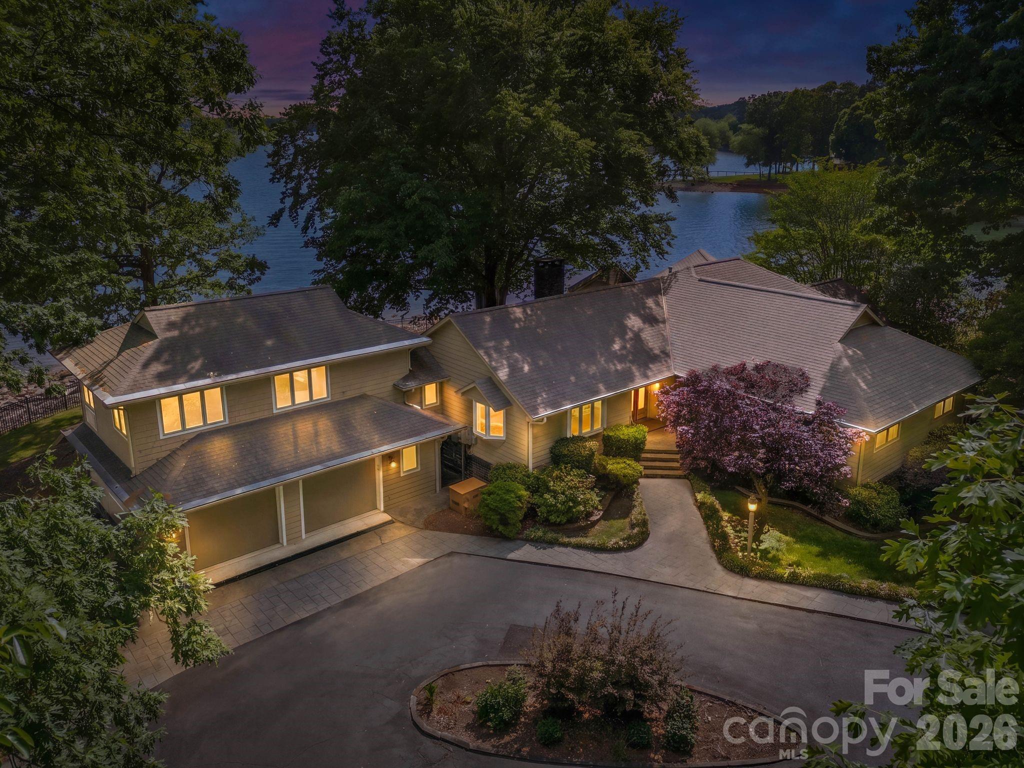 Positioned on a coveted stretch of waterfront, this distinguished residence is defined by its extraordinary setting and timeless appeal. Not many nicer views than this on Lake Norman. Encompassing approximately 3,000 square feet, the home offers four bedrooms, three full baths, office, and a versatile bonus room or additional bedroom overlooking the water, perfectly capturing the home’s most breathtaking views while balancing comfort, function, and enduring charm. At the heart of the home, a dramatic vaulted great room showcases rare wormwood-accented walls and an impressive stone fireplace, creating a warm yet striking gathering space. Expansive windows frame uninterrupted water views, while multiple living areas invite both quiet retreat and elegant entertaining. The primary suite is a private sanctuary, featuring dual walk-in closets and a spacious en-suite bath. Just off the primary bedroom, a dedicated office with a wet bar offers an ideal space for work or relaxation, all within steps of your own retreat. Outdoor living is equally compelling. A sprawling multi-level deck extends toward the water, complemented by two screened porches for year-round enjoyment of the serene surroundings. The private pier, complete with dock and gazebo, along with a dedicated boat launch, offers seamless access to the water, making every day feel like a getaway. The grounds are a true highlight, featuring a beautifully established rose garden and mature flowering landscapes that provide color, privacy, and a sense of tranquility throughout the seasons. A gated entrance and two-car garage further enhance the property’s exclusivity and convenience. Rich in character and set against breathtaking waterfront vistas, this is a rare opportunity to own a home where craftsmanship, natural beauty, and location come together in perfect harmony. Complete with an impressive 352 feet of pristine waterfront. Architecture by Dennis Lehmann of Banner Elk NC. Full Video Tour and Photos: https://listings.skycampictures.com/3725-Kingfisher-Ln-Terrell-NC-28682-USA?mls=