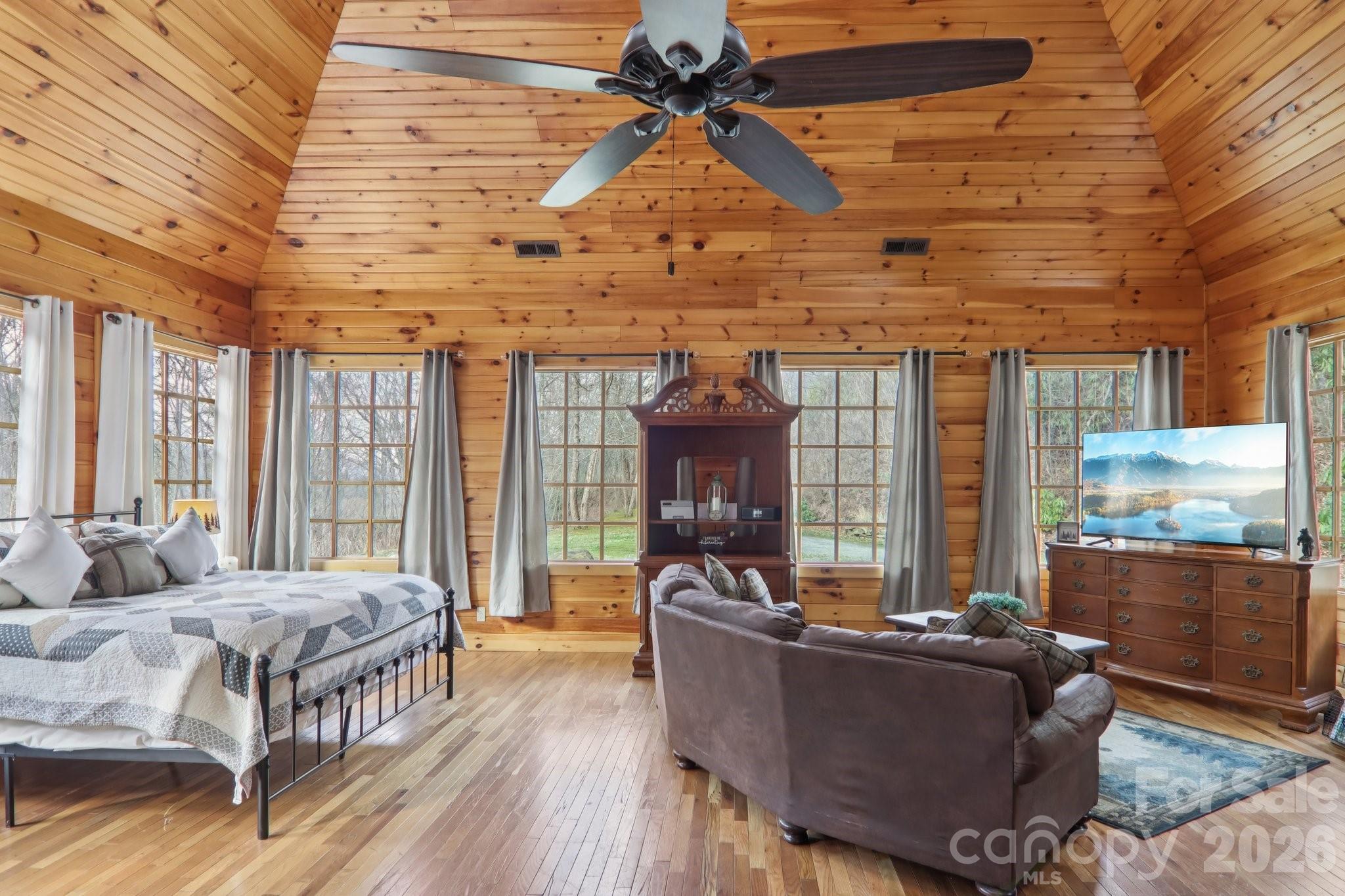 Tucked away on 2.43 private acres in the Alarka Highlands community, the ALARKA HIGHLANDS BUNGALOW offers a rare mountain setting with the soothing sounds of a rushing creek & a private path leading to your OWN SECLUDED WATERFALL. The spacious deck is the perfect place to relax with a fireplace for gatherings & a perfectly placed hot tub for a spa-like escape beneath the trees. A nearby firepit is just off the deck for cozy evenings under the stars. The home features a bright open studio-style layout where the kitchen, living area & sleeping space flow together in one inviting room. Large picture windows fill the space with natural light & frame the surrounding woods, while a stone fireplace anchors the living area with warmth & rustic charm. Alarka Highlands offers a community pavilion & tennis courts for owners to enjoy. Offered fully furnished & turnkey & already set up as a STR. It's about 25 miles from the entrance to Great Smoky Mountains Nat'l Park & the charming shops and eateries of Bryson City. This is the first home inside of the community with a paved road to the door. Alarka Highlands Bungalow is the affordable Smoky Mountain investment you’ve been waiting for.