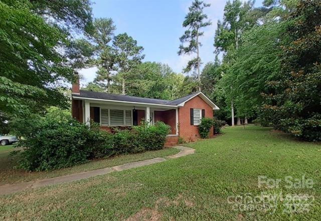 8.64 acres with Rental Home on Charlotte Highway - Beautiful brick home with 3BR and 2BA, living room and kitchen.  Flooring is hardwood and vinyl.  This home has a charming rear screened porch and a double, detached garage with plenty of room.  ***NO PETS***