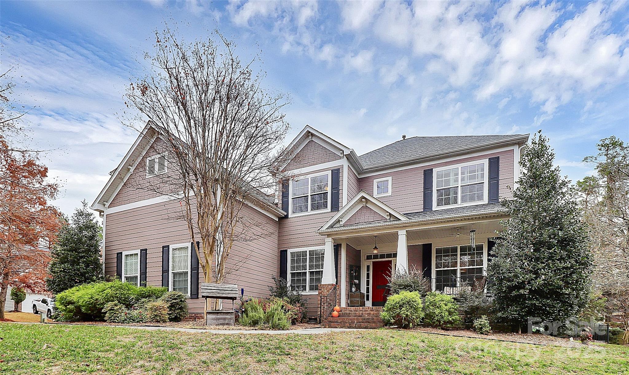 A must-see gorgeous home in the heart of Tega Cay that was thoughtfully designed to meet your every need! Imagine living on an oversized corner lot, in a peaceful community within walking distance to soccer fields, playgrounds, walking trails, Lake Wylie, and 27 holes of challenging golf. 1912 Newberry Lane is the perfect, impeccably maintained home that will put your home search to rest. The 5BD/3.5BA home was custom built with every detail in mind. This home has a classic formal living and dining room. The gourmet kitchen, lined with gorgeous cabinetry, granite countertops and beautiful hardwood floors, open up to the cozy great room where entertaining is a must. The spacious owner's suite, on the main level, settles you in after a long day with the large garden tub and walk-in shower. Atop the beautiful staircase with wood treads, you will find an oversized bonus room, and four additional spacious bedrooms. Relaxation happens outside, as well. Warm up to a cozy fire on the stone patio, while listening to whispering waters from the elegant water feature.