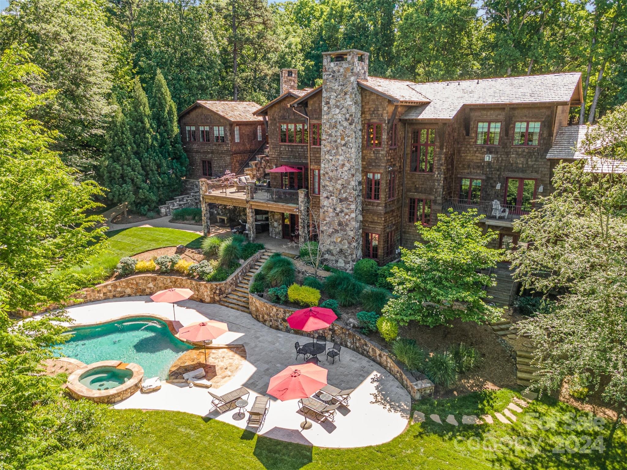 Amazing Price Improvement!!!! Preferred lender offering up to $20,000 in closing credit, subject to down payment amount. Has options to put as little as 10% down and close within 30 days! 
Nestled on the beautiful Lake Wylie, this extraordinary lodge-style retreat on 2+ acres, beckons with its rustic elegance and unparalleled craftsmanship. Boasting 5 bedrooms and 6 bathrooms, a private theater, exercise room, large basement and incredible outdoor living space complete with pool and additional studio dwelling unit above the detached garage, this home truly offers you everything you need! Just next door is all the top tier amenities at The Camp, including the private neighborhood boat dock. offering the privacy of surrounding natural beauty and refined comfort, this lakeside home offers a sanctuary of serenity unlike any other.