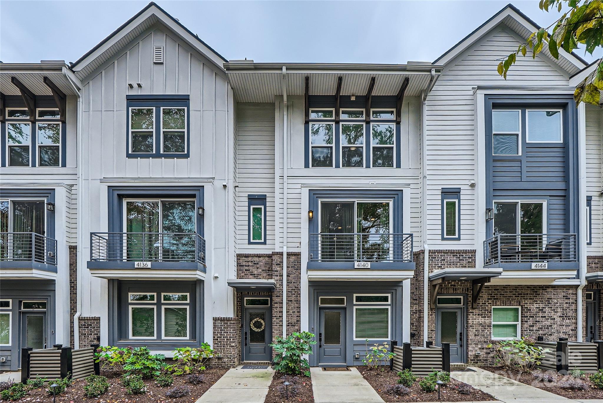 Located in highly sought-after Cotswold & built in 2021, this move-in ready townhouse feels like new construction! Offering 2 bed 2.5 bath plus bonus area, it boasts private views of lush greenspace, nestled in a quiet neighborhood. Open-concept design features beautiful hardwoods throughout main level & an abundance of natural light! Exquisite chef’s kitchen is equipped with 42” white cabinets, quartz counters, under-cabinet lighting, double trash pullout, pantry & gas range– seamlessly connecting to an outdoor balcony! The primary suite features a gorgeous wall of windows, upgraded bathroom oasis & a newly installed closet system from Container Store. Upstairs, you’ll find a versatile flex room– perfect for an office or bedroom. Plus a spacious ROOF TOP terrace! Tandem Garage w/ ample room for two cars & storage; new washer & dryer 2024; tankless waterheater; custom blinds; pull down attic w/ storage; TWO outdoor spaces! Enjoy modern comfort & convenience in the heart of Charlotte.