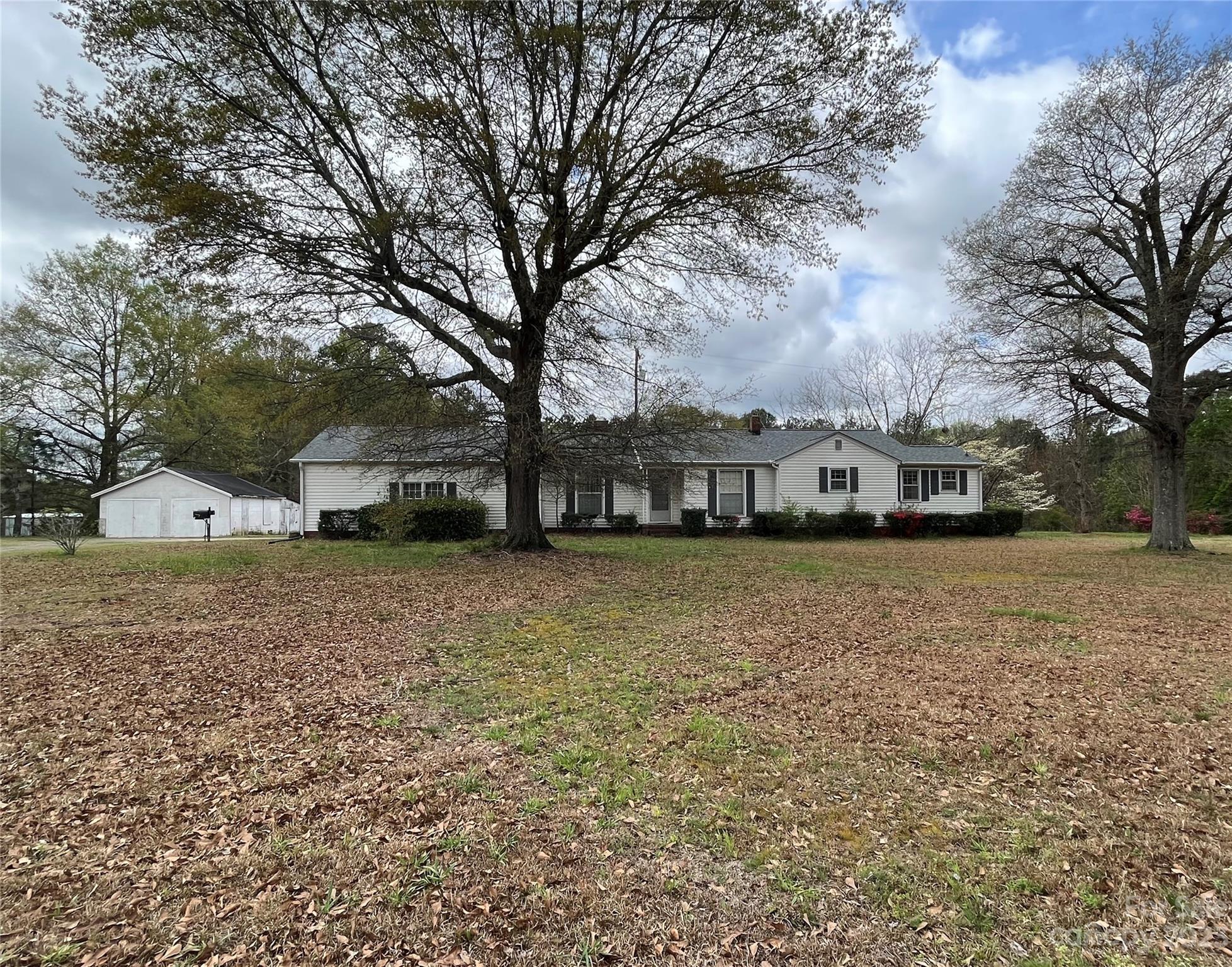 This home, sitting on over 11 acres, has served the original owners since 1951.  The potential that exists for this house and property is unlimited.  Featuring three bedrooms, one-and-a-half baths, large kitchen, dining room, living room with fireplace, and laundry room, the home has original wood floors and pine paneling.  An oversized double garage is attached and a detached garage that needs some TLC could serve many purposes.  The roof and septic system were replaced two years ago!  The seller does not plan to make repairs and is selling this home in as is condition.