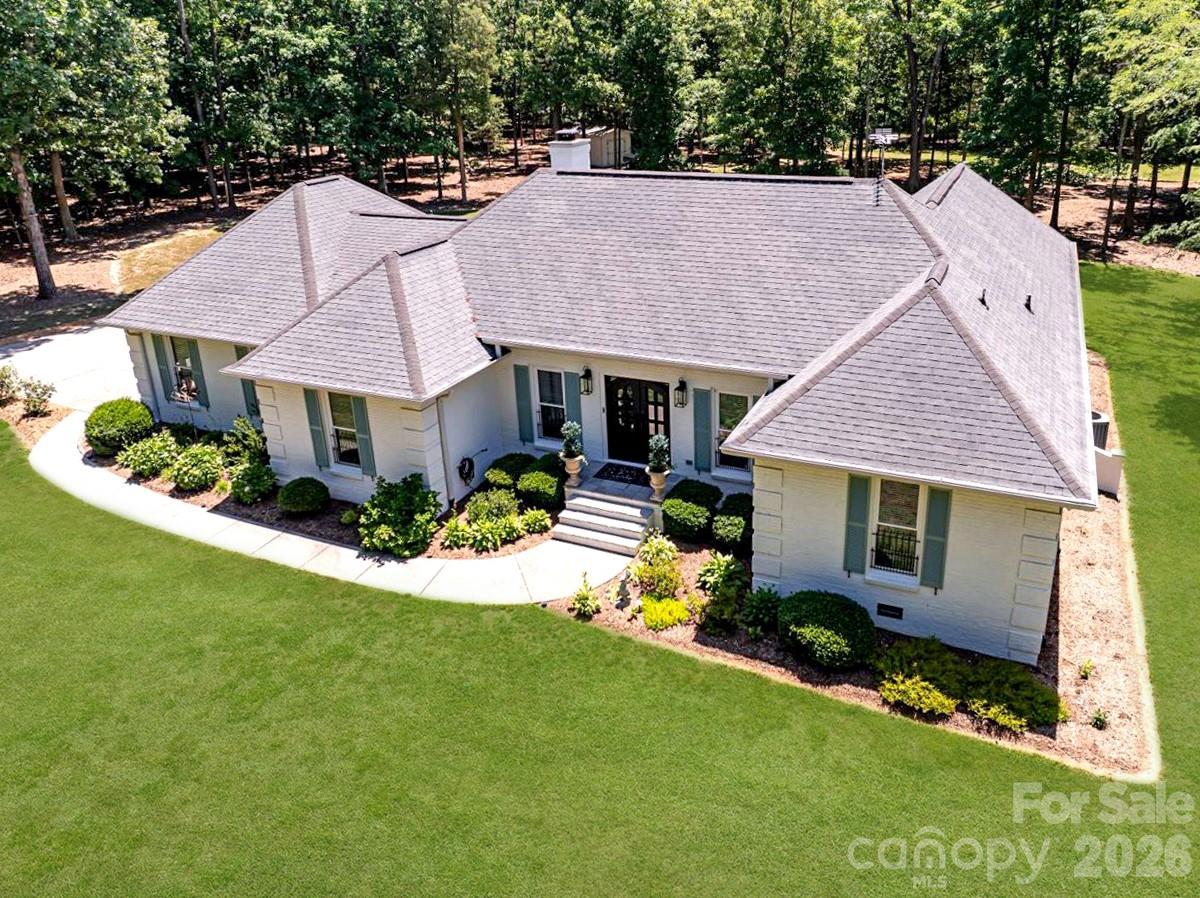 Welcome to 11100 Tara Oaks Drive—an exceptional, beautifully renovated full brick ranch home nestled on 3 private acres in a Mint Hill neighborhood of upscale homes. Blending timeless French country charm with modern luxury, this move-in-ready home offers the perfect balance of elegance, comfort, and everyday functionality.

Every major system has been thoughtfully updated within the past five years, providing peace of mind for years to come. Enjoy a high-efficiency Lennox variable-speed heat pump with built-in dehumidifier, UV air purification, new ductwork, a Rheem composite water heater, RainSoft whole-house water filtration system, and a new well pump and controls.

Inside, you'll find a warm, inviting interior featuring luxury vinyl plank flooring throughout, freshly painted walls inside and out, maintenance-free windows and doors, and a stunning custom iron double front entry. The beautifully redesigned kitchen and bathrooms showcase custom cabinetry, premium countertops, updated tile, stylish fixtures, and modern appliances.

The spacious primary suite is filled with natural light and offers a spa-inspired oversized, low-threshold walk-in shower for both luxury and convenience. A dedicated home office provides the flexibility today's buyers are looking for.

Step outside and discover your own private retreat. The expansive patio with a freestanding fireplace overlooks a breathtaking, park-like backyard framed by mature trees and lush perennial gardens. An additional outdoor firepit creates the perfect setting for entertaining or relaxing under the stars.

Additional highlights include an epoxy-coated garage floor, abundant storage throughout, custom lighting, a large storage shed, landscape lighting, oversized gutters with gutter guards, and underground drainage.

Designed for effortless single-level living, this remarkable home also offers exciting future potential with a spacious, high-ceiling attic ready to possibly be transformed into additional living space.

If you've been searching for a home that offers privacy, luxury, efficiency, and impeccable updates on acreage—without sacrificing convenience—this is the one. 11100 Tara Oaks Drive is more than a home; it's a lifestyle.