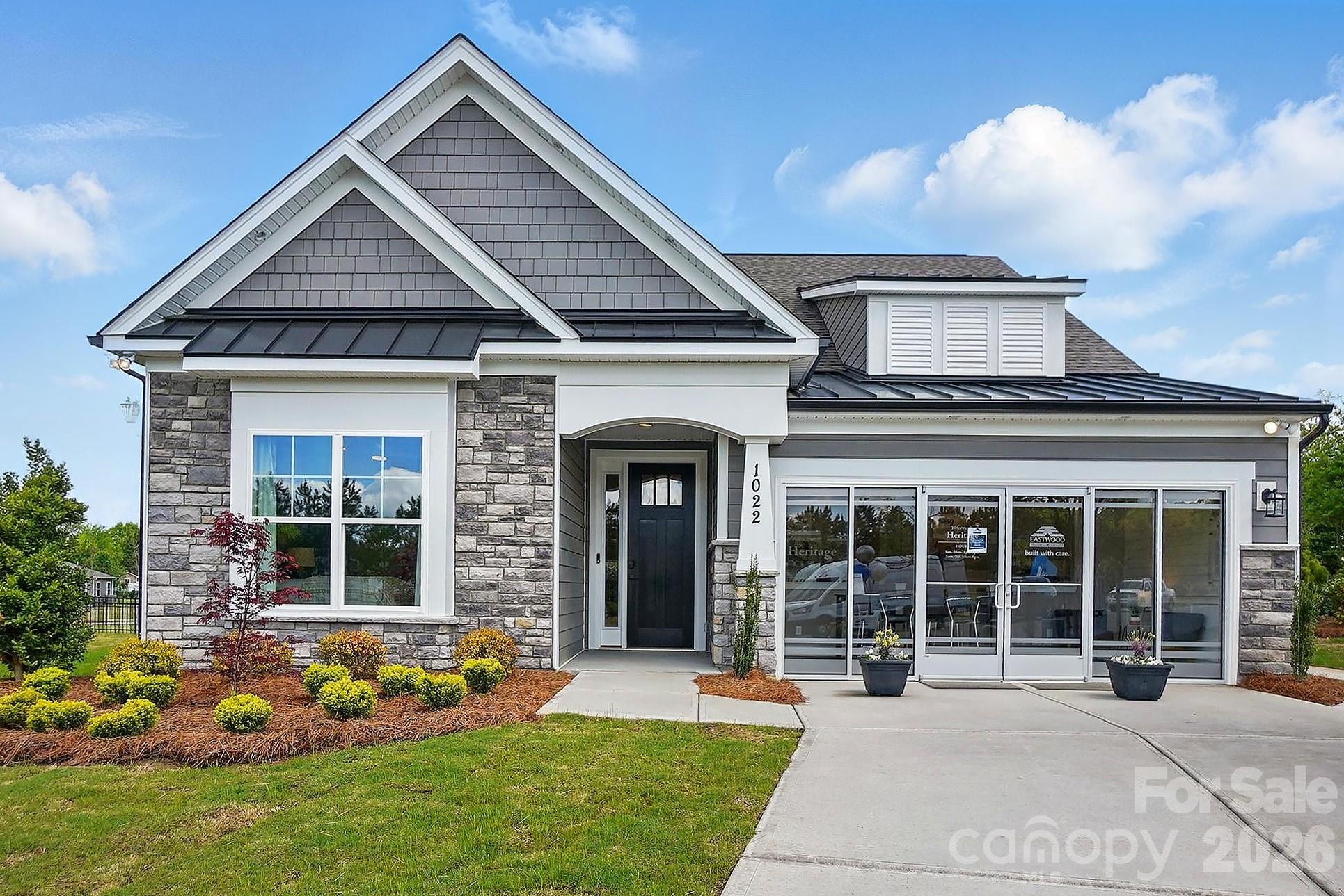 Welcome to the stunning Wescott model home, in the highly desirable 55+ Heritage community; showcasing thoughtful design, elegant finishes, and exceptional upgrades throughout. One of the final opportunities available in the community, this beautifully appointed home offers an exceptional blend of comfort, style, and functionality. This home features 3 bedrooms and 3 full bathrooms, with two bedrooms conveniently located on the main level, including the luxurious primary suite. Upstairs, you'll find an additional bedroom, full bath, and spacious loft, providing the perfect space for guests, hobbies, or a secondary living area. The open-concept main living area is highlighted by a spacious family room featuring a corner gas fireplace with a slate surround and stylish shiplap accent wall. The gourmet kitchen is designed to impress with white soft-close cabinetry, matte black hardware, quartz countertops, a tile backsplash, stainless steel appliances including a French door refrigerator, upgraded lighting, a walk-in pantry, and a bright breakfast area complete with cabinetry extended from the kitchen for extra storage and functionality. Just off the garage entry, a convenient drop zone provides the perfect space for everyday organization. Ideal for both entertaining and working from home, this Wescott home features a formal dining room and a dedicated office accented by a beautiful faux coffered ceiling. The primary suite offers a tray ceiling, a private sitting room with double doors, a spacious walk-in closet, and a luxurious private bath featuring dual vanities with quartz countertops, tile flooring, an upgraded tiled shower with bench seat and semi-frameless shower door. The secondary main-level bath includes a beautifully tiled 4-foot shower with bench seat, while the upstairs bath features a tub/shower combination. Additional highlights include EVP flooring throughout the home, upgraded wall trim details, a laundry room on the main level with included washer and dryer, built-in cabinetry, and a utility sink. The staircase showcases metal balusters paired with durable composite stair treads, adding both style and functionality. Enjoy outdoor living on the covered rear porch overlooking a paver patio with outdoor firepit and seating wall. The home's exterior showcases attractive stone accents, enhancing its curb appeal and timeless design.

Every detail has been thoughtfully selected to showcase the quality and craftsmanship that make this home truly special. This professionally designed Wescott model home is loaded with upgrades and offers an exceptional opportunity to own this popular floorplan. Schedule your appointment today to tour!