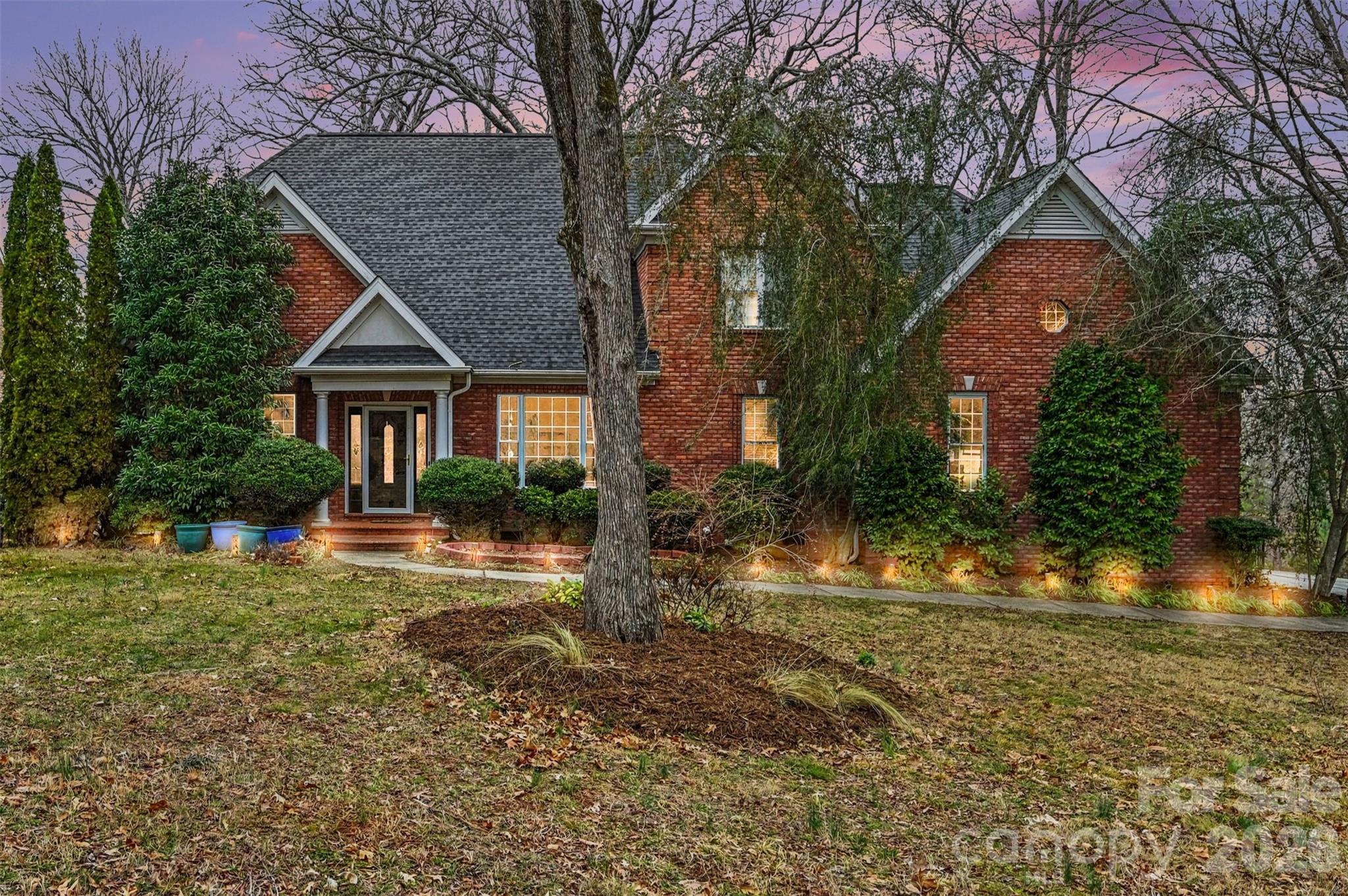 This beautifully maintained full brick home in Regent Park offers 3,294 square feet of thoughtfully designed living space on a private, wooded .40-acre lot, located on a private street that will soon be gated — an enhancement already approved by the HOA and scheduled for installation. From the moment you enter, you’re welcomed by an impressive foyer, gleaming wood floors, and an open, flowing layout ideal for both everyday living and entertaining.

The main level features a spacious primary suite, providing comfort and convenience with serene backyard views and direct access to the home’s elegant living spaces. The primary bath offers a spa-like feel with a garden tub, separate shower, and generous vanity space, creating a relaxing retreat at the end of the day. Also on the main level are a dedicated office, dining room, breakfast area filled with natural light, and a large family room with a gas fireplace that anchors the space beautifully.

Designed for gathering, the kitchen includes an island peninsula with additional seating, a gas cooktop, wall oven, abundant cabinetry, pantry, and a reverse osmosis water filtration system for added convenience and quality. The open floorplan connects the kitchen seamlessly to the living areas, while large windows frame peaceful wooded views. Flooring throughout the home includes hardwoods, tile, and carpet, blending warmth and durability. Additional interior highlights include walk-in closets, ample storage, a main-level laundry room, and thoughtful updates throughout.

Upstairs, you’ll find a second primary suite, offering flexibility and privacy, complete with its own ensuite bath and a private sauna for a true at-home retreat experience. Two additional bedrooms, another full bath, and a flexible bonus space perfect for a media room, playroom, or lounge area complete the second floor.

Outdoor living is where this home truly shines. The private, wooded backyard creates a peaceful setting rarely found, offering both space and privacy, and is fully fenced for added security and enjoyment. A double rear deck spans the back of the home, featuring a covered lower level and expansive upper deck, providing multiple areas for entertaining, dining, or simply relaxing while taking in the natural surroundings. The home is also equipped with a whole-house generator, offering peace of mind year-round.

Residents enjoy access to Regent Park's community amenities including a pool, playground, tennis courts, and walking trails. This is a rare opportunity to own a spacious, well-appointed home with two primary suites — one on the main level and one upstairs with a private sauna — exceptional outdoor living, premium features, and the added privacy of a soon-to-be gated street in one of Fort Mill’s most desirable communities.