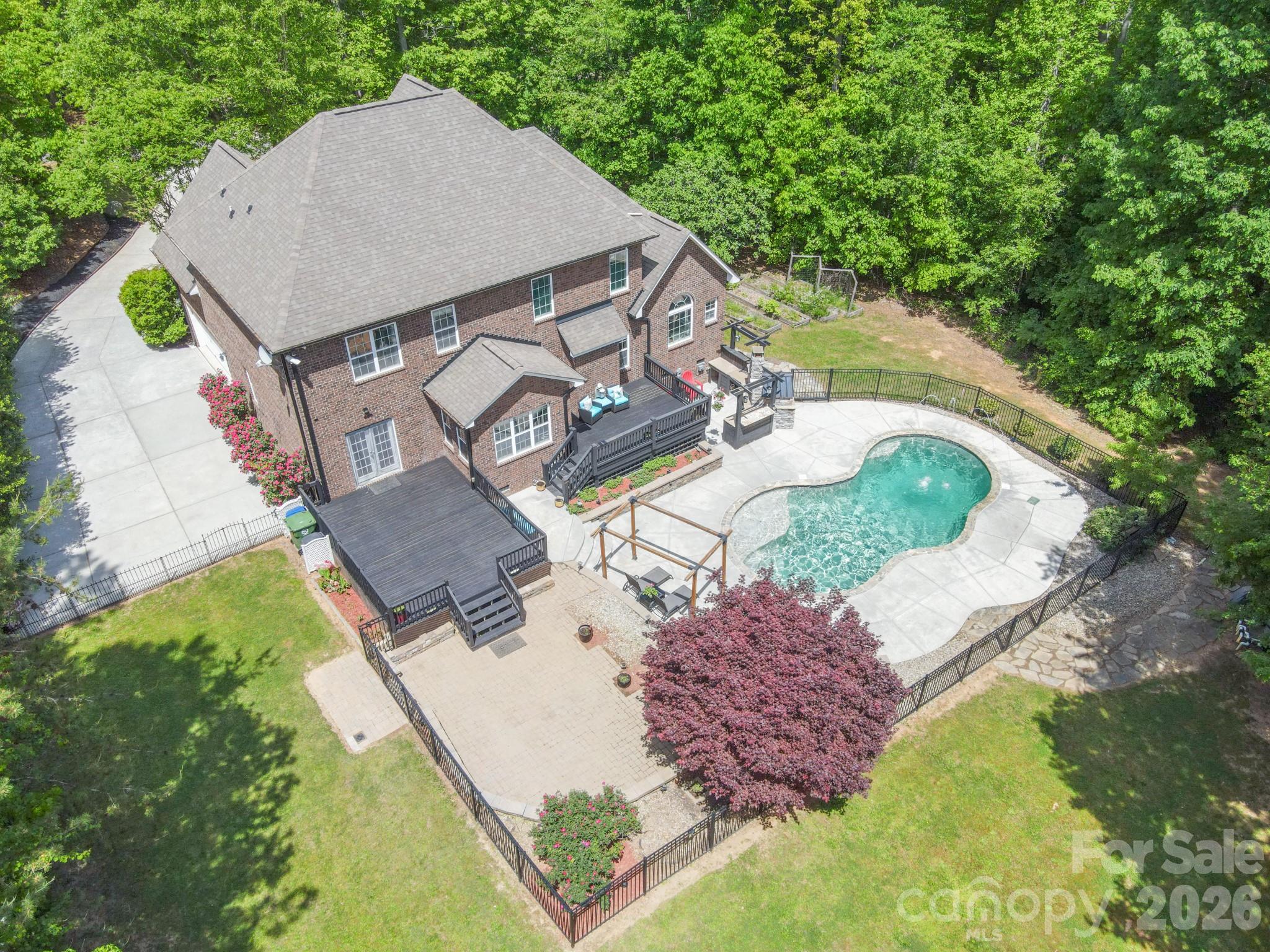 This beautifully designed home at Shady Oaks Drive in Stanley, NC features 4 bedrooms plus 2 additional bonus rooms currently set up as bedrooms (septic permitted for 4 BR), offering the perfect blend of comfort, flexibility, and thoughtful upgrades throughout. The property includes a private backyard retreat with an in-ground pool and is situated in a serene cul-de-sac with no HOA.
Step inside to a stunning two-story great room filled with natural light, creating an open and inviting atmosphere ideal for both everyday living and entertaining. Just off the entry, a formal dining room provides versatility—perfect as a home office, den, or traditional dining space to suit your lifestyle.
The main level is designed for convenience, featuring a spacious laundry room and a luxurious primary suite complete with a private sitting area, dual closets, and a spa-like en-suite bath boasting a large walk-in shower with dual showerheads. A separate guest suite on the main floor offers privacy and comfort, with its own en-suite bath and sliding glass doors that open directly to the back deck overlooking the backyard shimmering pool.
At the heart of the home, the kitchen impresses with a large granite island, abundant cabinetry, and two pantries—including a walk-in—making storage and organization effortless.
Upstairs, you’ll find a generous loft space along with four additional bedrooms, each offering spacious closets. While the home features six bedrooms in total, the septic system is permitted for four.
Outdoor living at Shady Oaks is like resort style living at home, with the custom pool with fountain jets, huge fenced backyard, dual rear decks, and a patio complete with a built-in pizza oven—perfect for gatherings or relaxing evenings under the stars. Exterior lighting on a timer ensures seamless day-to-night ambiance.
Additional highlights include a whole-home speaker system, two-zone HVAC with a smart thermostat on the main level, and thoughtful details throughout that enhance both comfort and convenience.
This home truly offers space, flexibility, and standout features—ready to fit a variety of lifestyles.
Pool has Fountain Jet at left end.  Pool filter replaced every 3 months.
Recent Update: 2024 - Backyard fence installed. 2025 - Pool pump replaced and Septic pumped, Well serviced. Matterport link:  https://my.matterport.com/show/?m=jrHjuQcfp4a