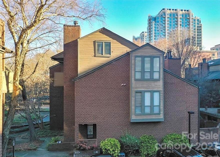 LOCATION, LOCATION, LOCATION…Lowest priced 2 bedroom in Uptown! Freshly painted and move-in ready. These units rarely come up for sale. Located in the heart of Fourth Ward just blocks away from Panther’s Stadium and BB&T ballpark.  Convenient to the uptown parks, restaurants and all that Uptown has to offer.  Ground level private entrance with private courtyard and storage shed in back of unit.  This home features hardwoods downstairs with open floor plan, stainless steel appliances, double oven, granite counters, tiled backsplash and wood-burning fireplace.  Upstairs offers 2 bedrooms and 1 bath with 2 separate sink vanity areas as well as 2 laundry and storage closets.  HVAC new in 2022. Washer/dryer and refrigerator to convey with purchase. One assigned parking space (#7) with additional resident parking available directly behind on 8th Street with permit.  2 hour visitor parking available in the same lot.
