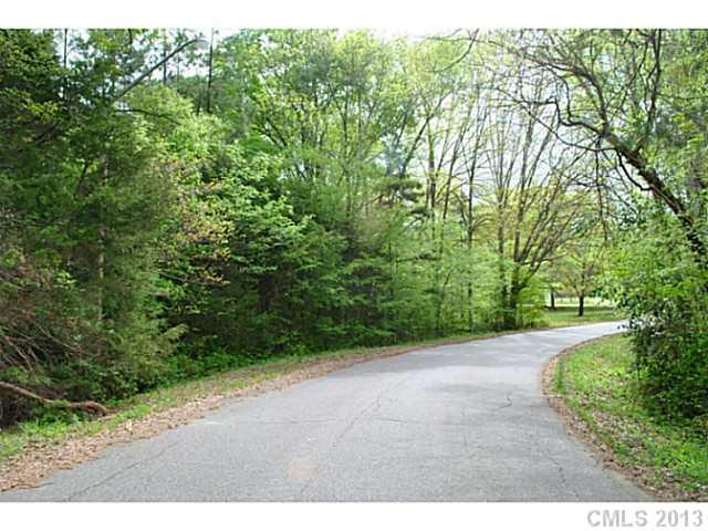 Wooded lot on 1.16 Acres in the Rock Hill Country Club. Backs to church parking lot. Leave some trees for buffer or clear all for a huge flat yard.