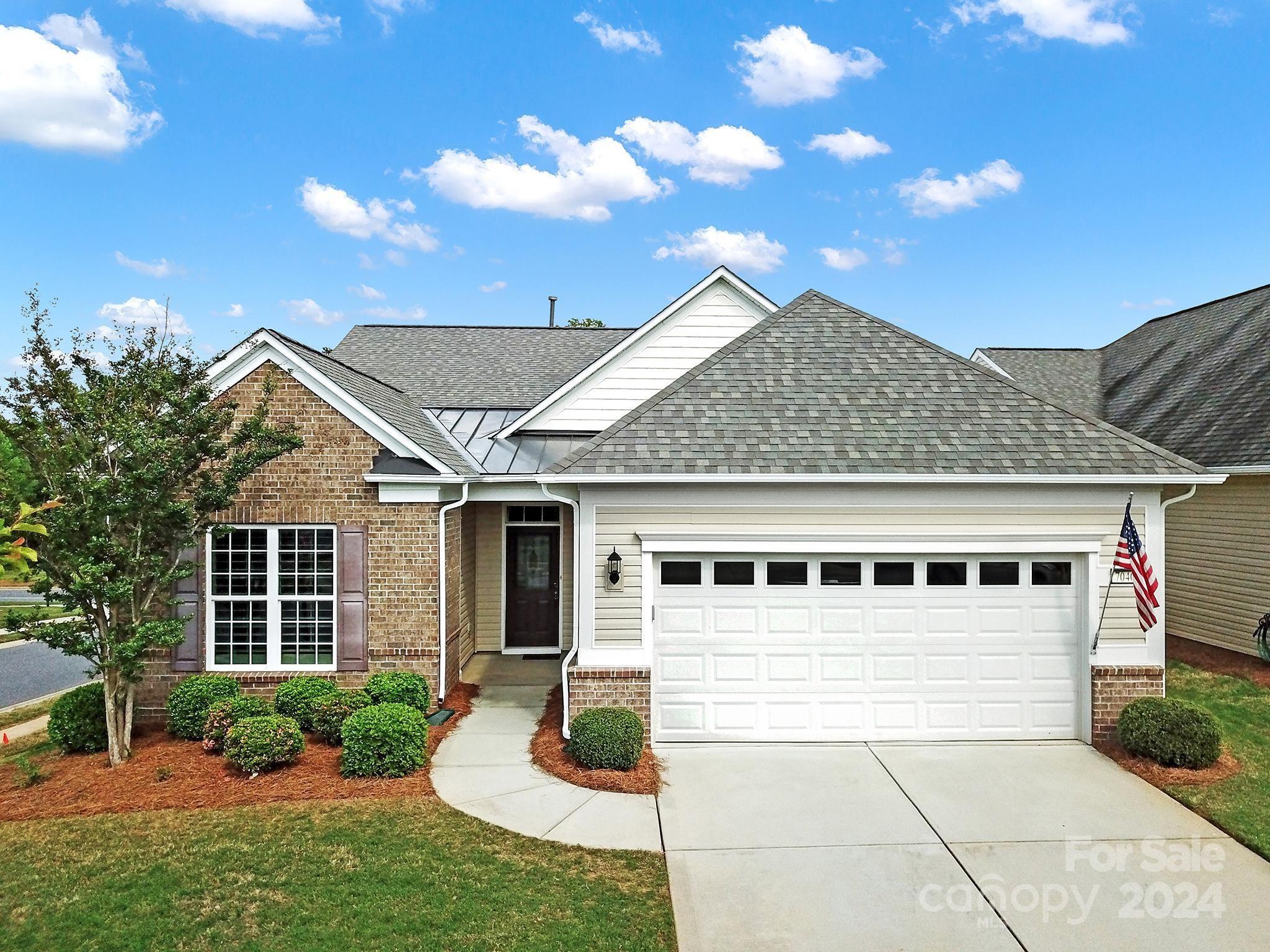Beautiful Tifton Walk on a corner lot in 55+ Sun City! From the curb, you are welcomed by the partial brick front, manicured garden beds, & a decorative glass front door. Hardwoods flow throughout the home w/ tile in the bathrooms, & plantation shutters add a touch of elegance on most of the windows! The open floorplan features a kitchen w/ granite counters, electric appliances, a corner pantry, & an island w/ a bkfst bar overlooking the great room. The primary suite is at the rear of the home w/ a tray ceiling & an ensuite bath w/ a dual sink vanity, large glass shower, & a walk-in closet. 3 guest bedrooms have access to a full hall bath & are great for overnight guests. Or, use the additonal bedrooms as a home office or hobby room! Soak up the sun on the spacious rear covered patio! Other features: a whole-home water filter, air scrubber, & an extended garage w/ a sink & pulldown attic access for storage! Come see this home today!