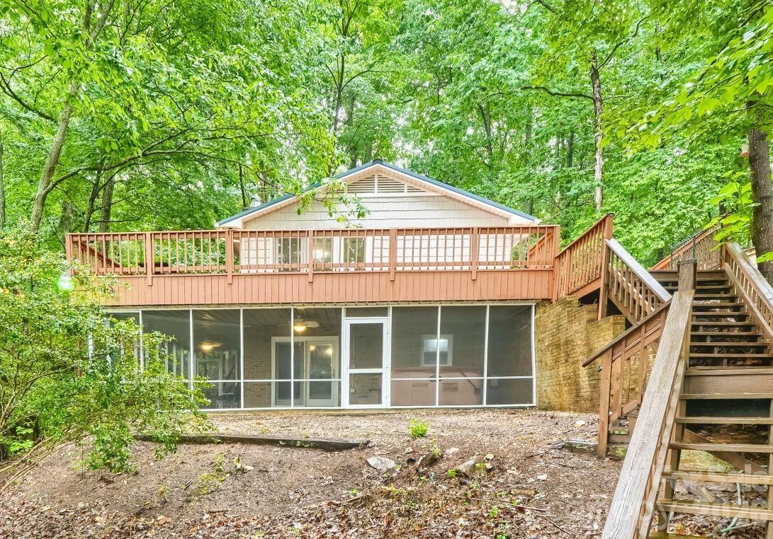 Seller to pay your closing cost up to $5000.00 with acceptable offer! Check out this gorgeous lakefront retreat on Badin Lake situated on a private 1.22-acre lot with breathtaking views of the Uwharrie Mountains and National Forest. This beautifully updated cottage offers the perfect blend of privacy, comfort, and lake living. The cottage has new LVP flooring on both levels. The kitchen has been completely refreshed with granite countertops, backsplash, appliances, sink/faucet, lighting, and fresh paint. The living room features updated lighting, and fresh interior paint, creating a bright and inviting space to relax and enjoy the breath taking views. Enjoy cozy evenings by the wood-burning fireplaces located in both the main-level living room and the lower-level entertainment room. The bedrooms have also been updated with paint throughout. Also take a look at the gorgeous remodel on both bathrooms. Additional improvements include a refinished staircase leading to the charming rustic style basement, a fully functioning second kitchen with new granite counter-tops, beautiful backsplash, and new basement appliances, and an entertainment / family room with updated lighting. While the lower level bed/bonus room offers a closet, there are no windows. Outdoor upgrades make this property even more impressive with a fully screened wraparound slate patio complete with a hot tub, a freshly stained/painted wrap around upper deck, new water lines, and a new well pump system. Enjoy peace of mind with a metal roof less than five years old, chain-link fencing for added privacy, and multiple storage options with a workshop/storage shed and an additional storage building located close to the pier. The true showstopper is the waterfront setting, with easy access to the lake and pier by either stairs or driveway. Enjoy peaceful lakefront living with stunning year-round views of the mountain and national forest in this move-in ready getaway.