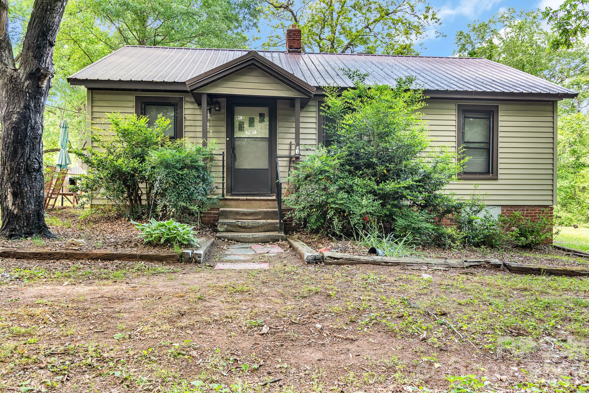 HANDYMAN/INVESTOR SPECIAL!  Enjoy country living on 1.10 acres just outside the city limits! This 1950 farmhouse features a newer HVAC system and durable metal roof, offering a great starting point for your personal touches and updates. Conveniently located near restaurants, grocery stores, and everyday amenities while benefiting from no city taxes. An additional adjoining .57-acre lot is also available for purchase (Parcel 320032), providing even more possibilities. Property includes two storage buildings, and all personal property will convey. Well is currently not operable. Bring your vision and make this property your own!  Property sold AS-IS; seller will not make any repairs.