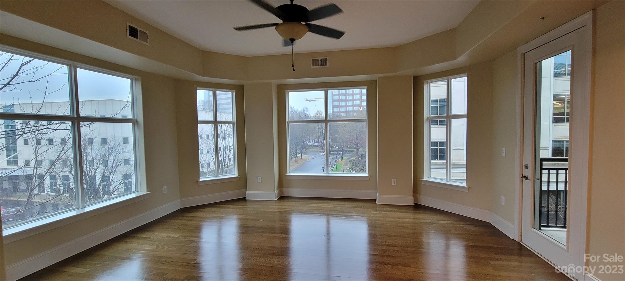 Welcome to this spacious and rare END unit in the heart of SouthPark at Piedmont Row! This unique layout, boasts one of the largest one bedroom floor plans in the building!  (only 6 in Piedmont Row). Upon entering, you will enjoy the roomy gourmet kitchen, granite countertops, large granite island, large kitchen cabinets with under cabinet lighting. Refrigerator was replaced in Jan 2020. Hardwood floors lead to the bright great room where living on the end unit makes all the difference! The great room windows (all replaced in Mar 2019) allow for plenty of natural light and great views of the surrounding area from the 5th floor! Relax and lounge on your semi private balcony accessible from your bedroom or great room. Large primary bedroom suite with walk-in closet. Enjoy the amenities with clubhouse, roof top pool, garage parking and plenty of general deck parking. Enjoy the lifestyle of all that Piedmont Row has to offer: live, workout, dine, shop and play!