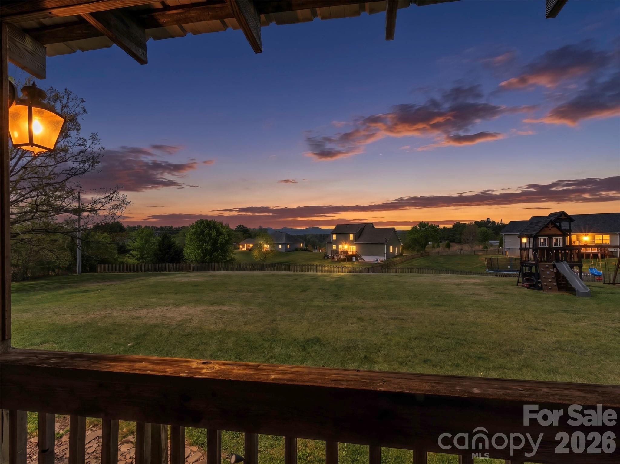 Welcome home to 120 Lillie Lane, a spacious and inviting 4 bedroom residence that perfectly captures the peaceful essence of all the Western NC mountains have to offer. This easy single level living home offers over 2,100 square feet of comfortable living space on a sprawling 1-acre lot. Designed for the ease of 1-story living the functional layout includes two full bathrooms and a designated laundry room to meet all your daily needs.  The interior features a warm entrance foyer and a single car garage that provides both convenient parking and additional storage. The property is a true standout, featuring a rare and desirable level lot that offers plenty of usable outdoor space. You can relax on the welcoming covered front porch while enjoying the mountain views- the perfect backdrop for taking in vibrant sunsets every evening. Conveniently located just 10 minutes to Marshall or Mars Hill  only 20 minutes to Weaverville.