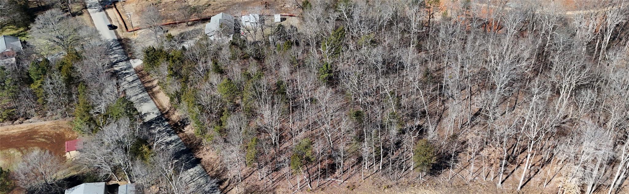 Discover the perfect canvas for your next project or forever home. This beautiful 2.86 acre wooded property offers privacy, space, and natural charm while just being 10 minutes from I-485 and shopping areas.