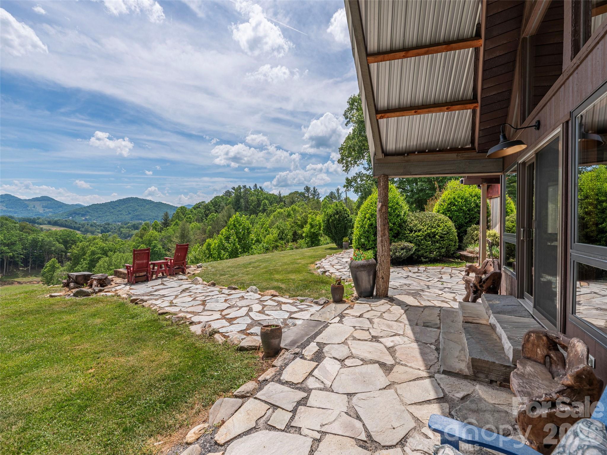 PRIME VIEWs with layered mountain ridgeline and great topography. This updated chalet offers an incredible private feel while remaining conveniently close to town, situated on 11 acres of beautiful pastoral land with truly breathtaking views.  In addition there is a three car garage, an old homestead barn, two firepit areas and no restrictions.  The home itself is a charming and fully updated chalet designed to highlight its natural surroundings with a stunning wall of windows facing the epic mountains. The interior features a large gourmet kitchen with an extended island, perfect for hosting. The main level includes a bedroom with a spacious walk-in closet and a glamorous primary bathroom equipped with a double walk-in shower and a soaker tub. Additionally, the upstairs loft offers views for miles and miles includes a second primary bedroom with its own private bath. Wonderful Investment property with longstanding vacation rental history or fully time residence for the next owner.