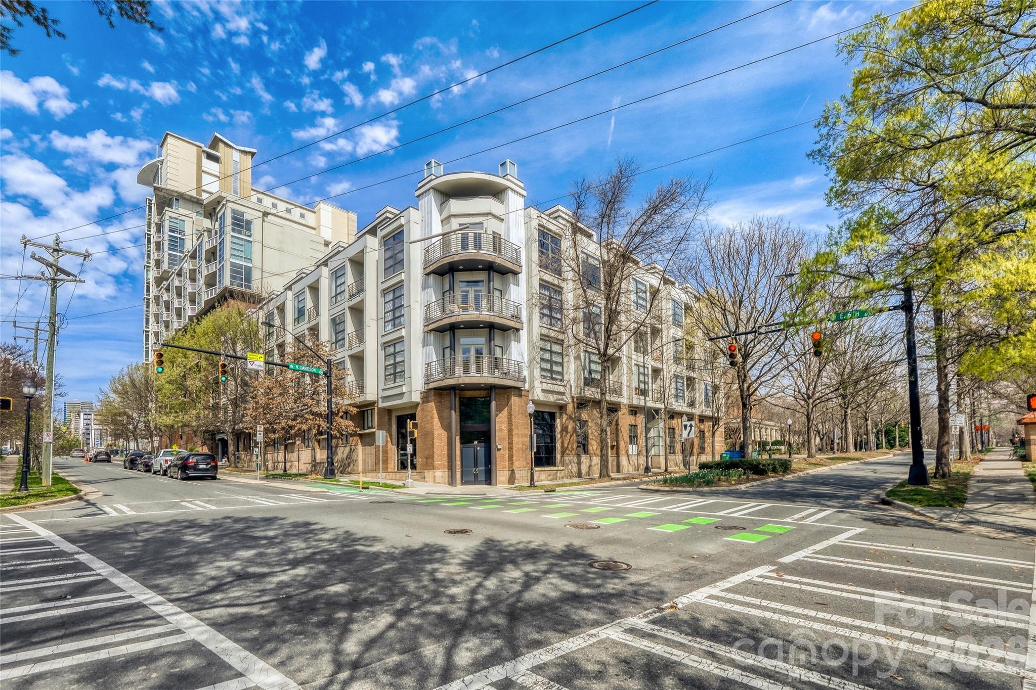 Awesome penthouse unit in Court 6 with tons of natural light, windows, views, AND $5,000 in buyer credits provided by the seller! This extra large corner-unit features windows on 3 sides and just steps from Spectrum Center & everything Uptown with a cool patio view, especially in the evenings! The unit features a large kitchen with island, dinning area, spacious living room, bedroom, full bath, walk-in closet, laundry, all in a open and airy concept yet still providing plenty of privacy. The condo lives open, easy & is great for entertaining with room for a full dinning table! Fully secured building and 1 deeded parking space in the deck is included. Freshly painted and move in ready this really is One of the best deals in Uptown right now! BOTH the HVAC and hot water heater have been replaced (2019, 2024) AND the unit has Google Fiber and loads of beautiful natural light.  Come take a look, and use the seller credits to buy down your rate or apply to closing costs!