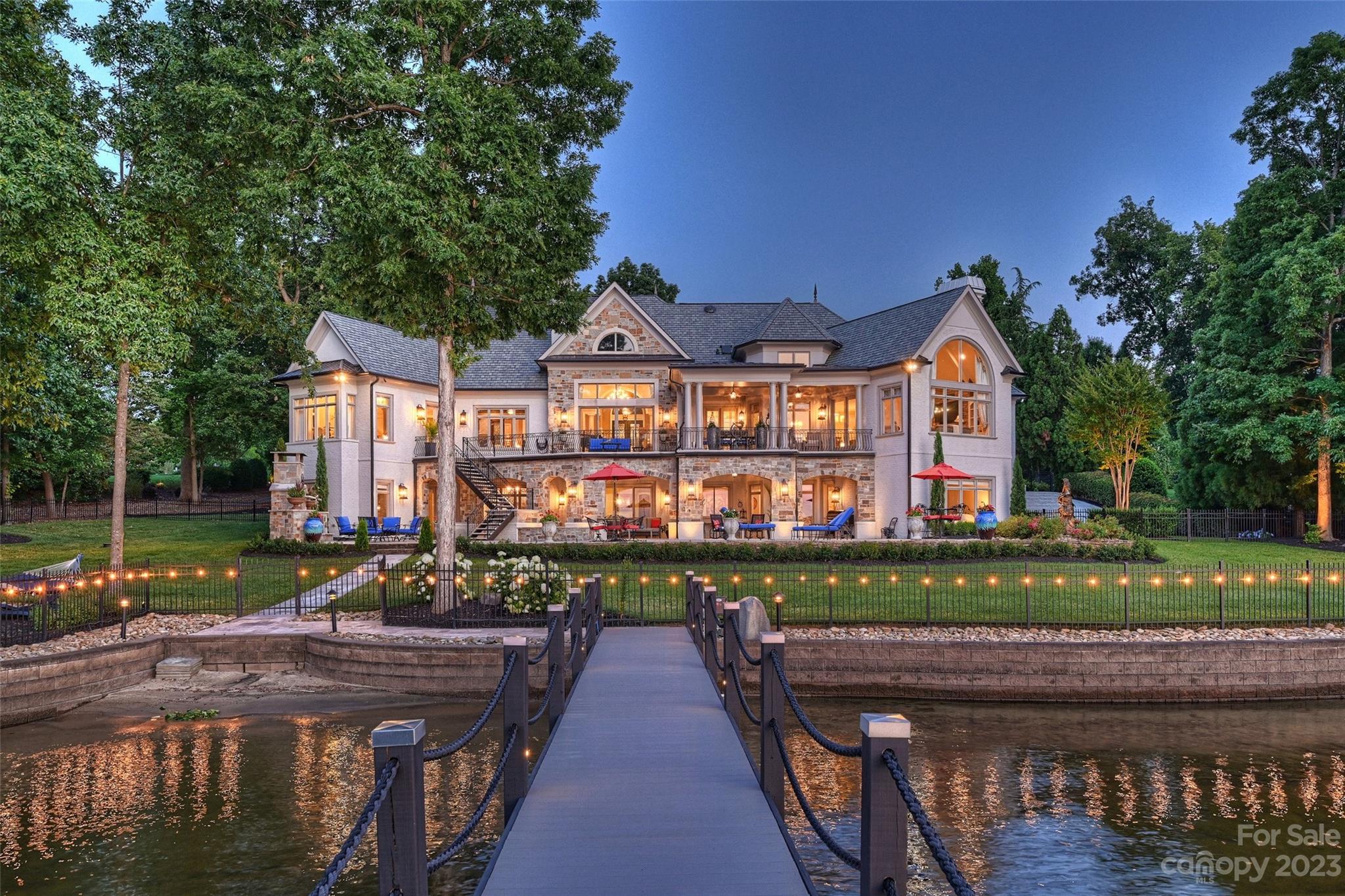 This one-of-a-kind lakefront home has recently been transformed both inside and out. From the newly redesigned gourmet kitchen to the 15 ft ceilings, you will find breathtaking lake views from every room. Not a detail was missed in this totally remodeled turnkey masterpiece. Two primary suites on the first floor makes having guest a comfortable decision. Entertaining was at the forefront when entering the lower level, complete with a bar, a billiard room, a wine bar, a golf simulation room, a home gym and two more guest suites all with 12-foot ceilings. You will find Custom drapery, intricate molding, detailed ceilings, exquisite chandeliers and an elevator add to the elegance of this home. The outdoor spaces feature a saltwater pool and spa, a fireplace, a new dock with two jet ski lifts and a 10,000-pound boat hoist, automatic boat cover, all surrounded by 220 feet of shoreline. If this isn’t the best lake view in The Point, it’s certainly one of them.