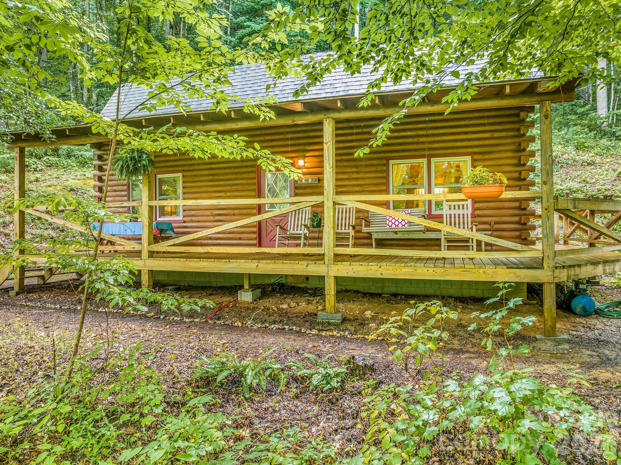 Welcome to your peaceful hideaway in the mountains, your perfect opportunity to relax & disconnect. This wood cabin is being offered furnished, all you'll need to do is bring your suitcase. It's tucked away in the Wild Acres neighborhood in a wooded, serene setting at 3,400 feet with gentle Summer breezes & lovely Winter mountain views. Inside, you’ll find two bedrooms & a full bath on the main level, with an airy loft upstairs that includes a bonus space (currently being used as a sleeping quarters, but home is on 2 bedroom septic), full bath, & laundry. The rustic, natural materials add to the charming cabin feel. Cozy up in the winter by the wood burning stove with a book, play a card game with friends, or enjoy a meal with the ones you love on the covered front porch. This home has been well cared for & in the same family since it was built. This is the first time it's been offered for sale. A great opportunity for a personal getaway or furnished rental—get ready to exhale & enjoy!