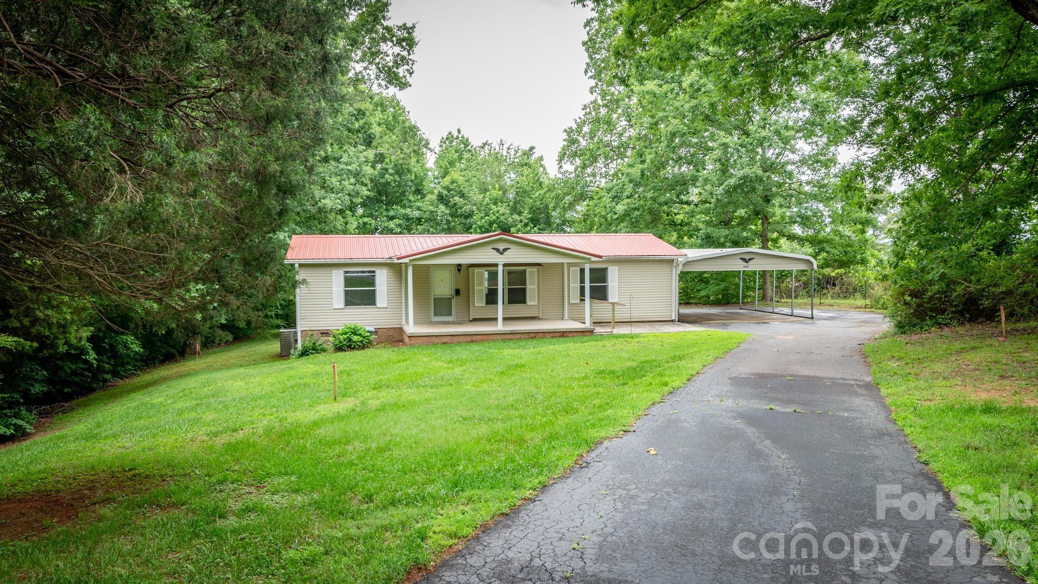 Well-Maintained 3 Bedroom, 2 Bath Home Situated on 1.69 Private Acres! This Move-In Ready Property Features Wall-to-Wall Vinyl Flooring, Fresh Interior Paint, Updated Light Fixtures, New Light Switches & Electrical Outlets, New Toilets, and New Front & Back Doors. The Functional Split Bedroom Floor Plan Offers Comfortable Living Spaces and Plenty of Natural Light Throughout. Outside, You'll Find a Large 2-Car Carport and an Impressive 25x24 Detached Garage Perfect for Vehicles, Storage, Workshop Space, or Hobby Enthusiasts. Enjoy the Peace and Privacy of Country Living While Still Being Convenient to Nearby Shopping, Dining, and Major Highways. Plenty of Room for Gardening, Recreation, or Simply Enjoying the Outdoors. Don't Miss This Opportunity to Own a Beautiful Home with Acreage and Exceptional Garage Space!