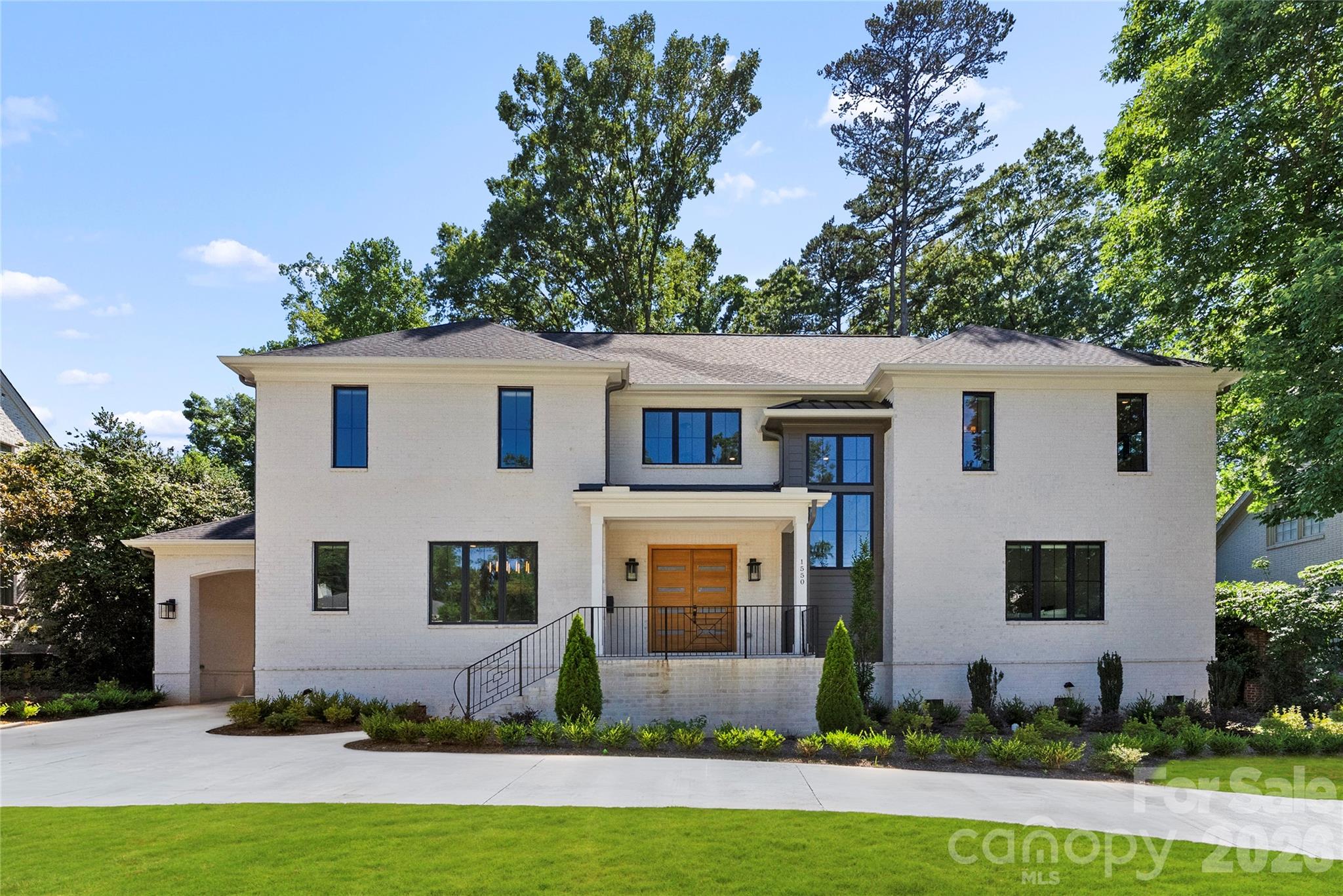 Positioned on a rare, private .45-acre homesite in the heart of Cotswold, this custom-built luxury residence offers an exceptional blend of thoughtful design, upscale finishes, and everyday functionality—just minutes from SouthPark, Uptown, top-rated schools, dining, and shopping. Designed for the way people live today, the wide-open floorplan creates seamless flow between the home's main gathering spaces while still maintaining warmth and character throughout.

At the center of the home, the chef's kitchen is both beautiful and highly functional, featuring premium appliances, a gas range with custom hood, double ovens, an oversized island, and an expansive walk-in pantry complete with a prep area, beverage station, and space for a second full-size refrigerator. The kitchen opens effortlessly to the spacious great room, where custom built-ins and a fireplace create an inviting atmosphere for entertaining or relaxing at home.

The main level offers incredible flexibility, including a private guest suite or secondary primary retreat with a large walk-in closet and spa-inspired bath, along with an additional room ideal for a home office, study, or flex space. Upstairs, you'll find three generously sized bedroom suites, each with its own private bath, plus a large bonus/media room perfect for movie nights, game days, a playroom, or recreation space.

Outdoor living is equally impressive. A covered rear porch with fireplace overlooks a secluded backyard setting with multiple flat terraces and endless possibilities. The upper portion of the lot offers potential space for a future pool, guest house, detached office, fitness studio, or ADU. Completing the property is a rare porte-cochere, a two-car garage, and substantial unfinished space above the garage ready to be customized to suit your needs.

Offering a combination of luxury, flexibility, privacy, and future potential that is increasingly difficult to find, this nearly new custom home presents a rare opportunity in one of Charlotte's most desirable neighborhoods.